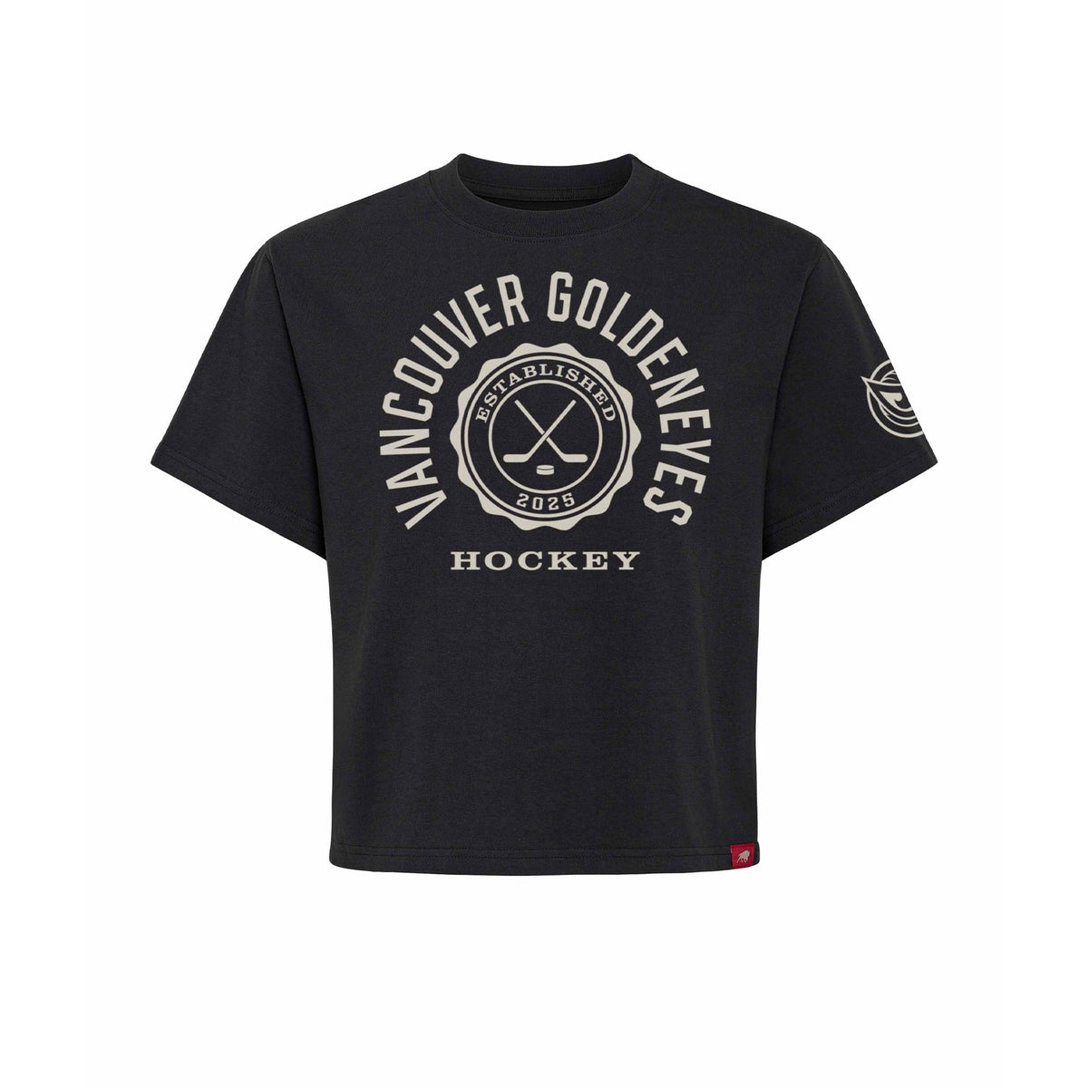 Front of a black short sleeve shirt. 'VANCOUVER GOLDENEYES' is written in a white arch of text around a circular emblem with crossed hockey sticks and 'ESTABLISHED 2025' inside with 'HOCKEY' below it. A white mono-color Vancouver Goldeneyes logo is on the left sleeve.