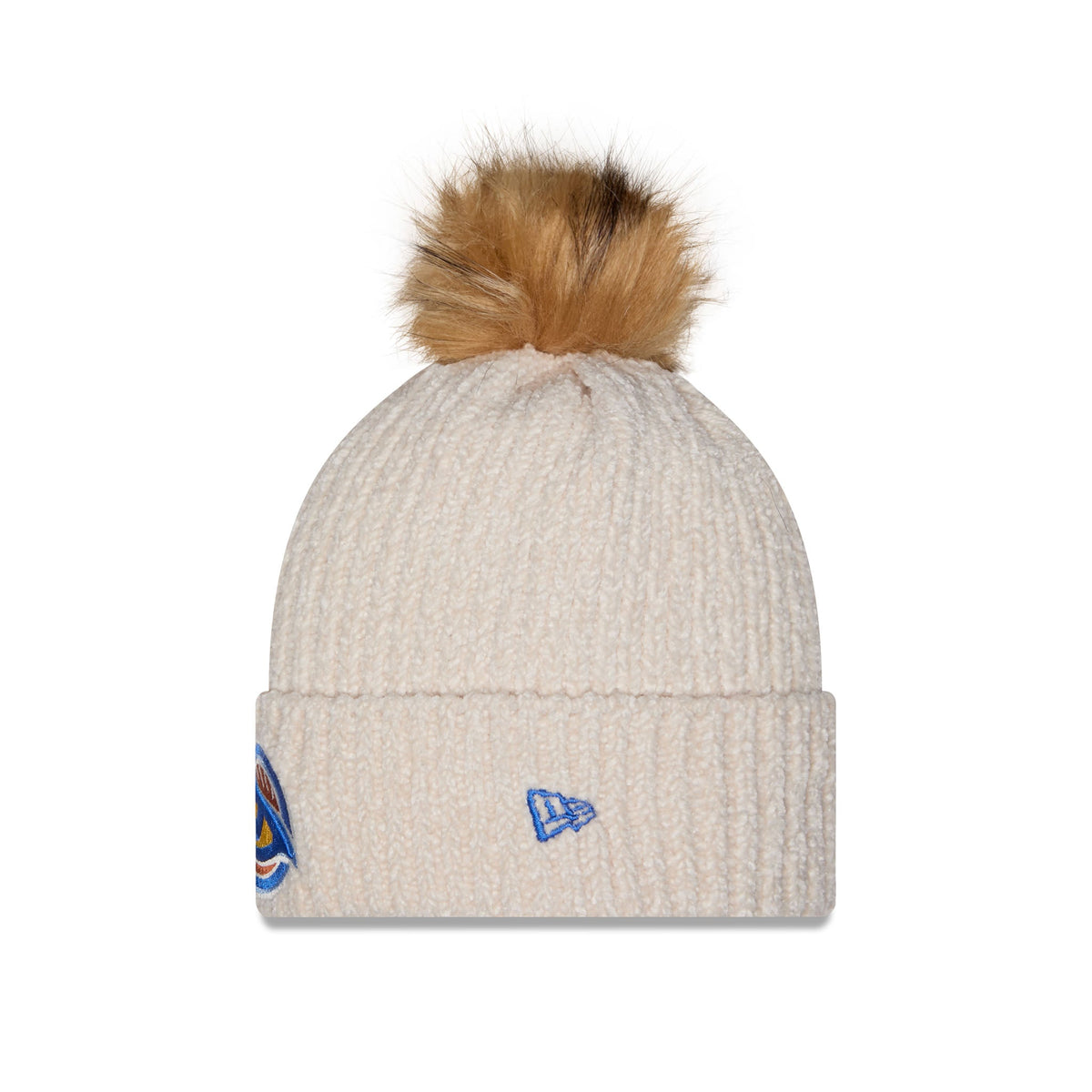 A cream-colored ribbed knit beanie hat featuring a fluffy tan and brown faux fur pom-pom on top. The front cuff displays a small embroidered blue New Era flag logo, and a partial multicolor graphic is visible on the side.