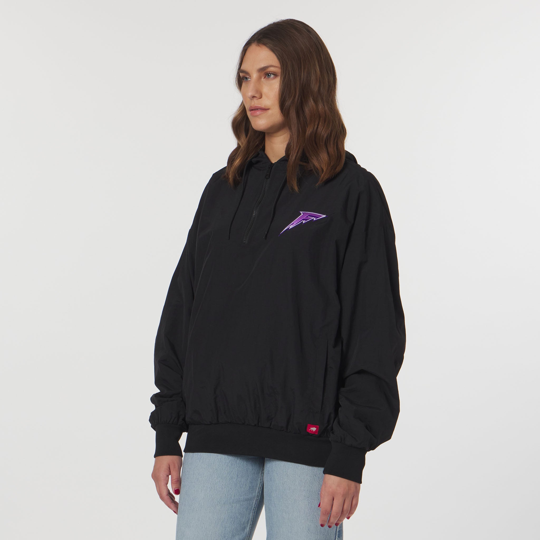 Person wearing a black hoodie with a purple logo on a white background