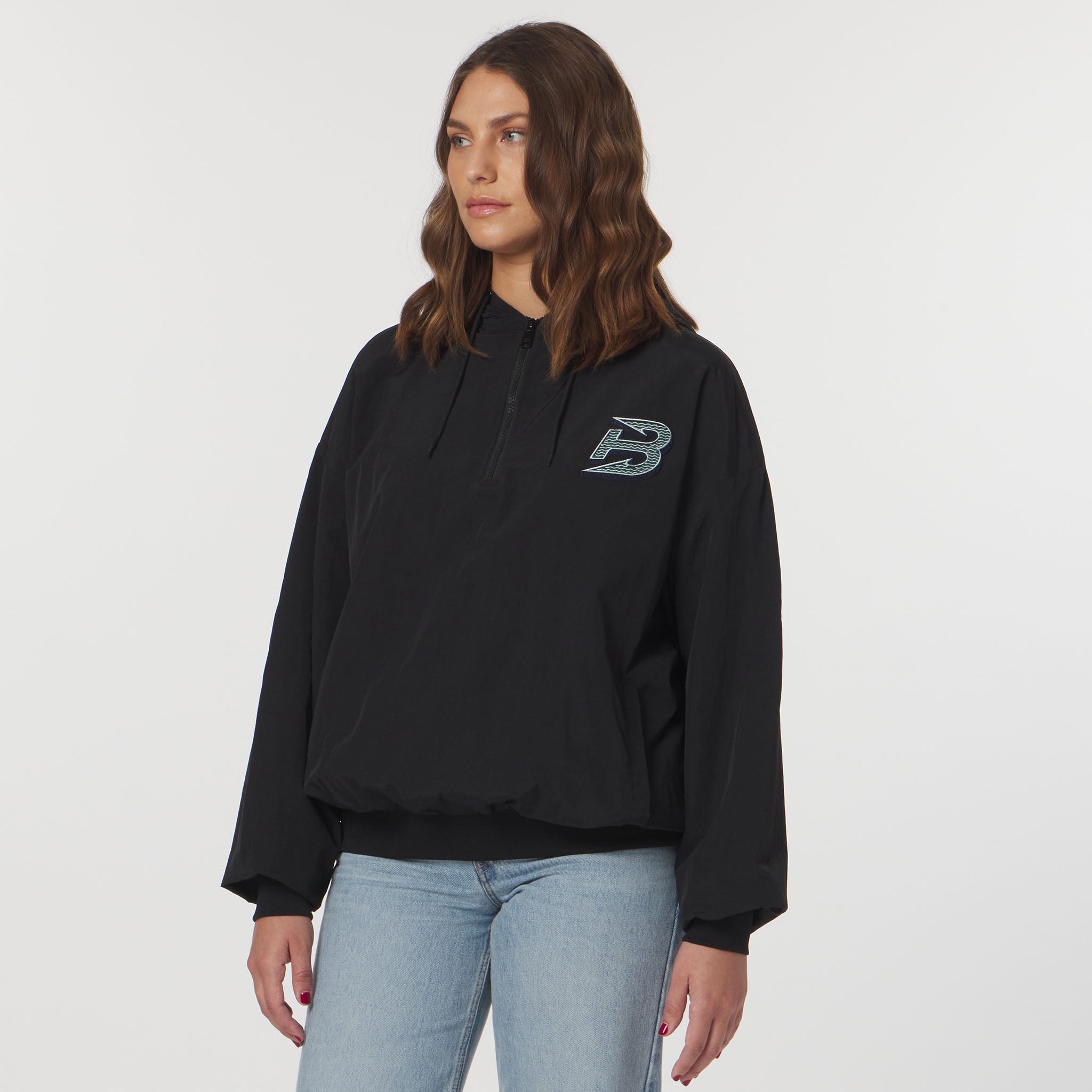 Person wearing a black hoodie with a logo on a white background