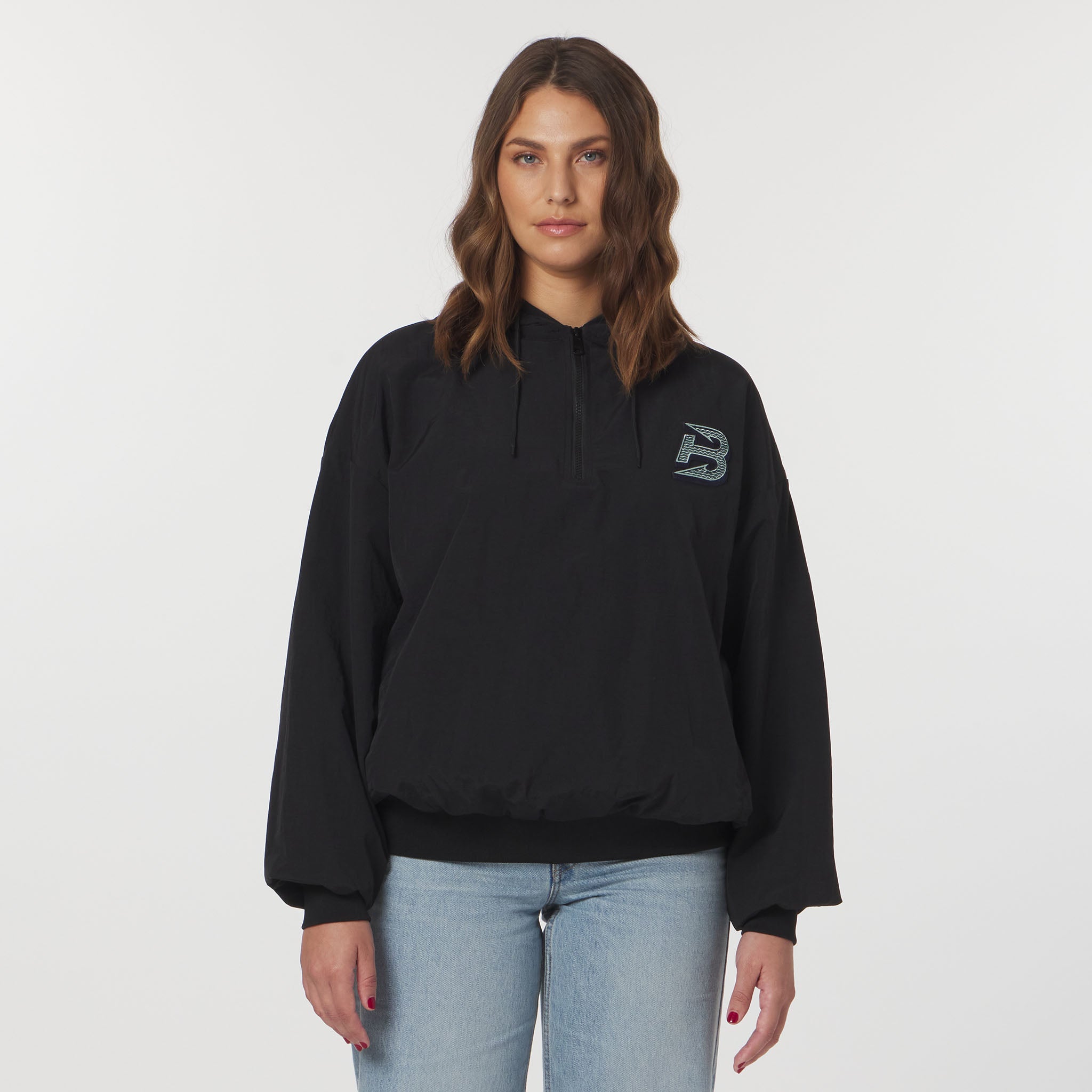 Person wearing a black hoodie with a logo on a white background