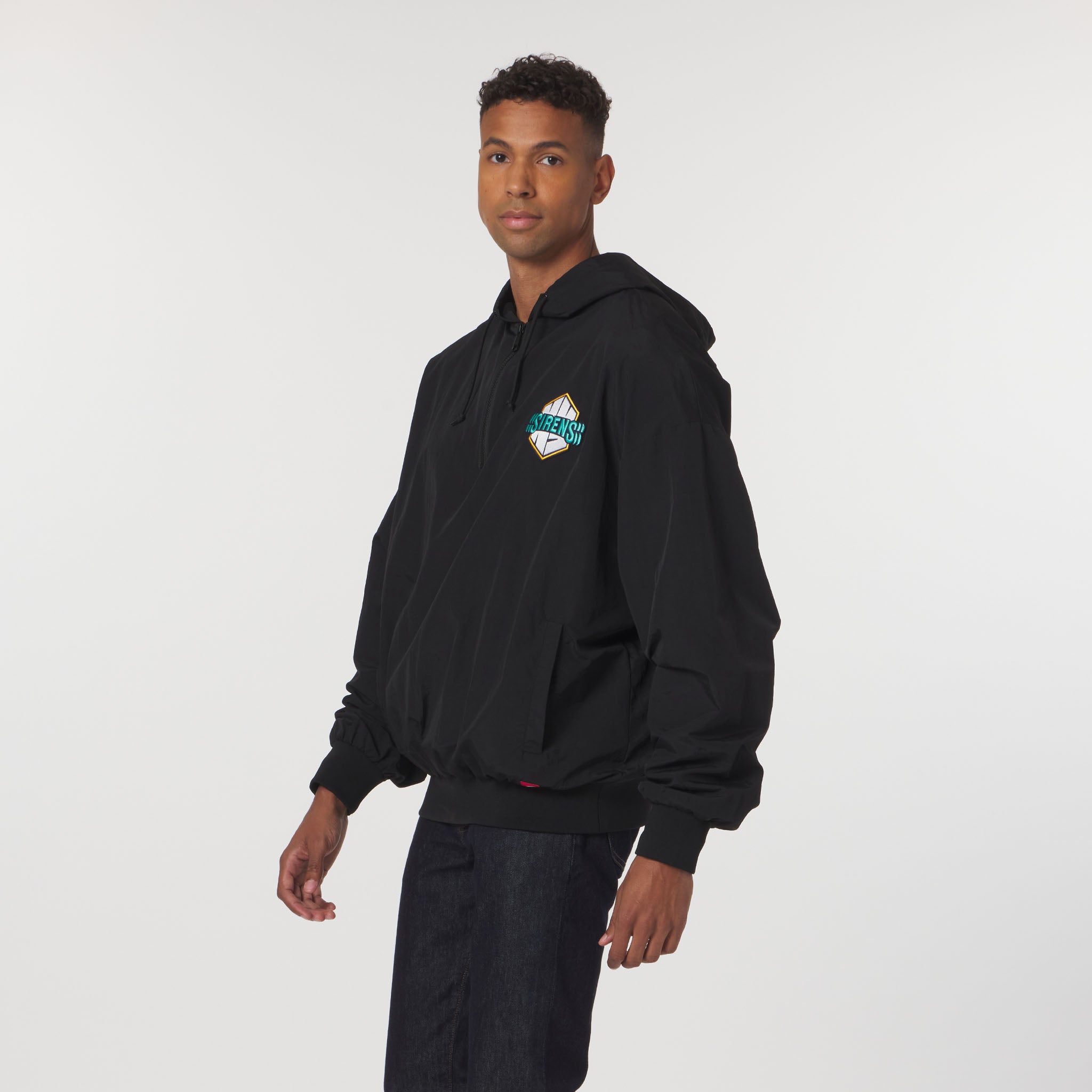 Person wearing a black hoodie with a logo on a white background