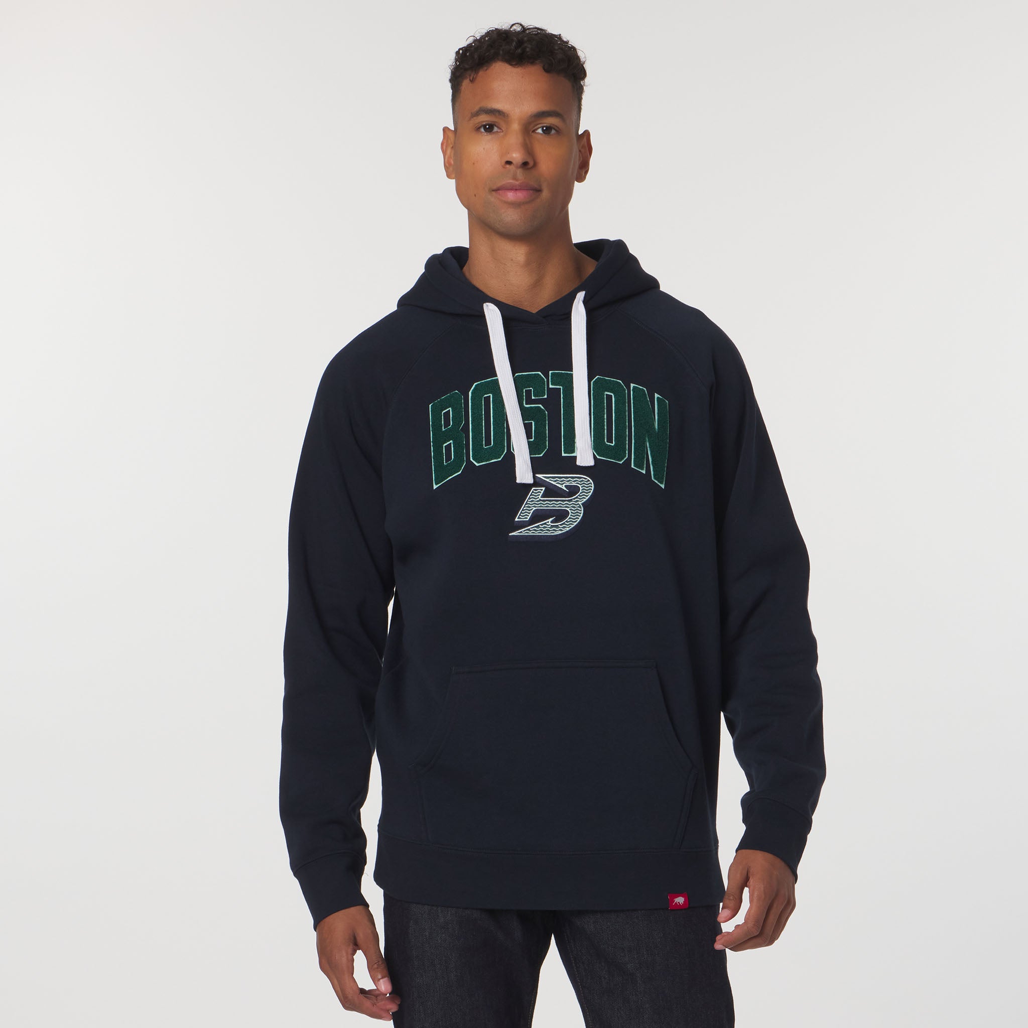 Person wearing a navy hoodie with 'Boston' printed on it against a white background