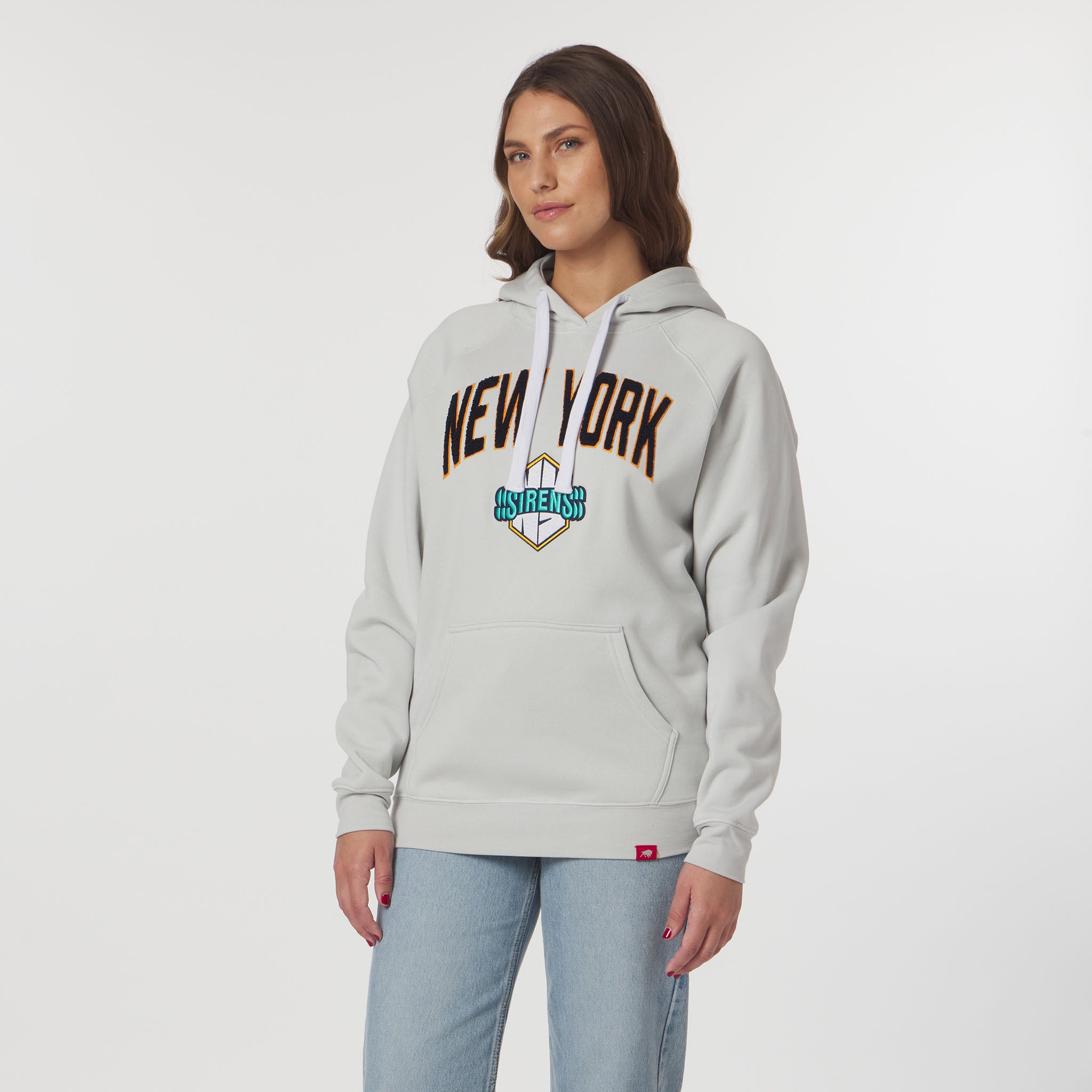 Woman wearing a gray hoodie with 'New York' text on a white background