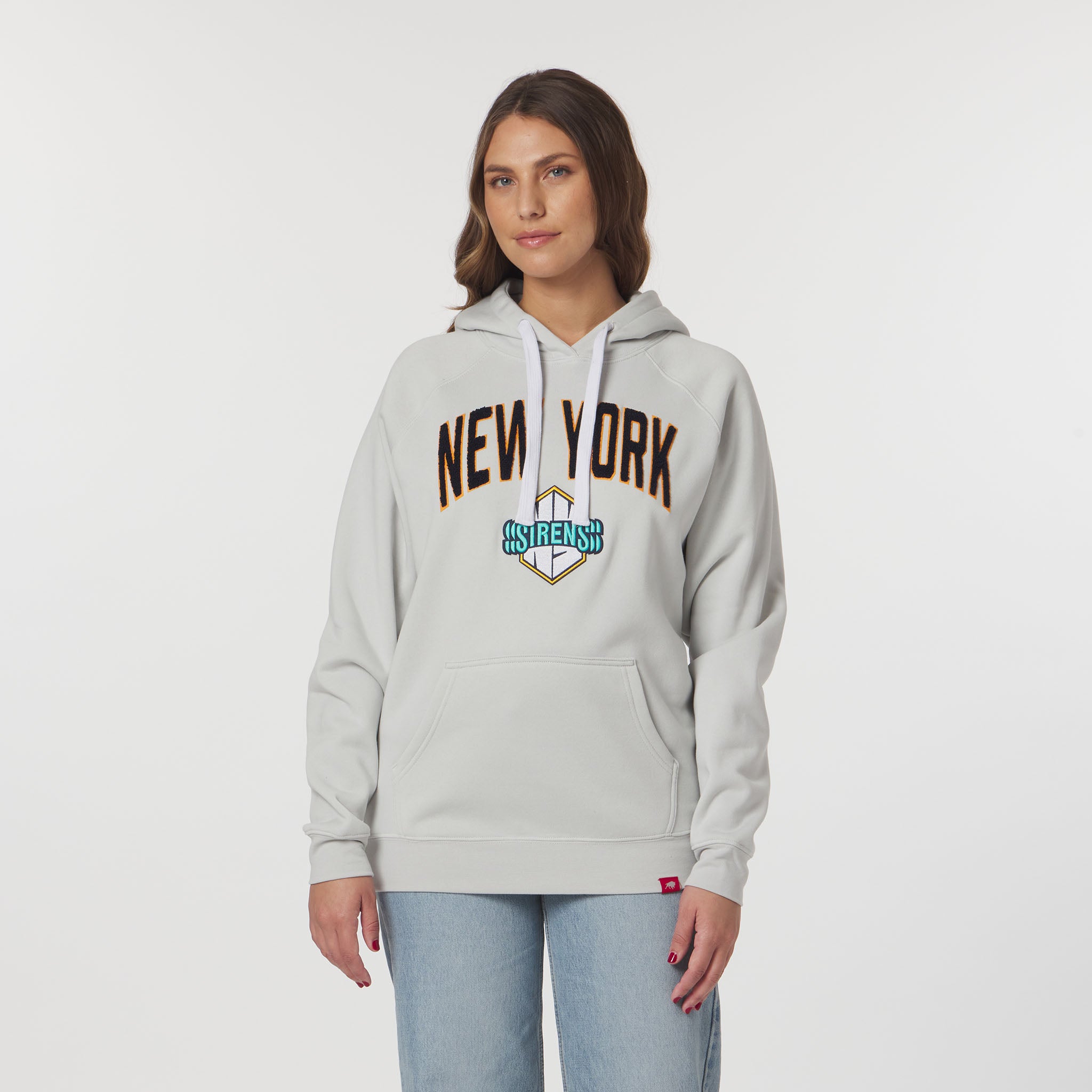 Woman wearing a gray hoodie with 'New York' text on a white background