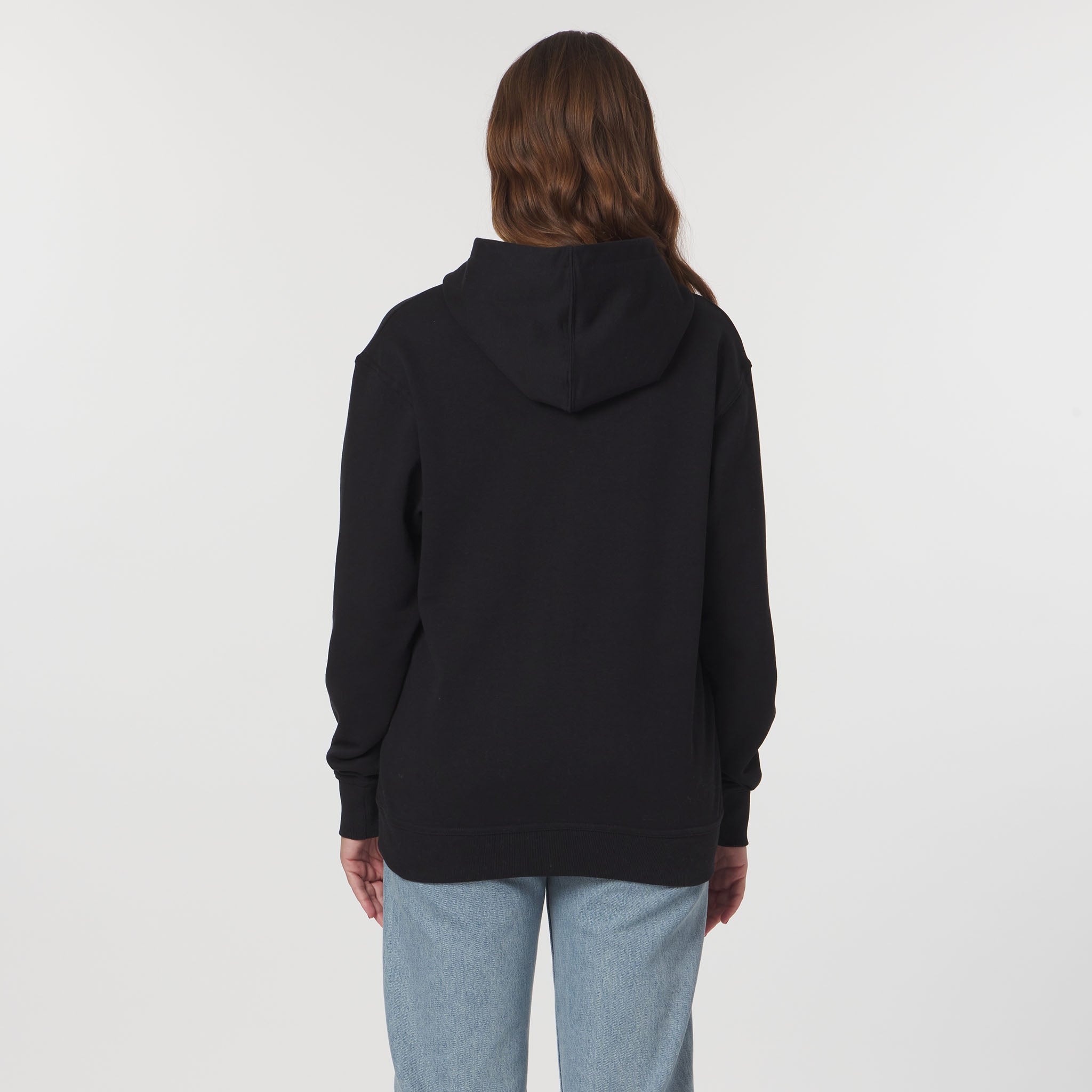 Person wearing a black hoodie from behind on a white background