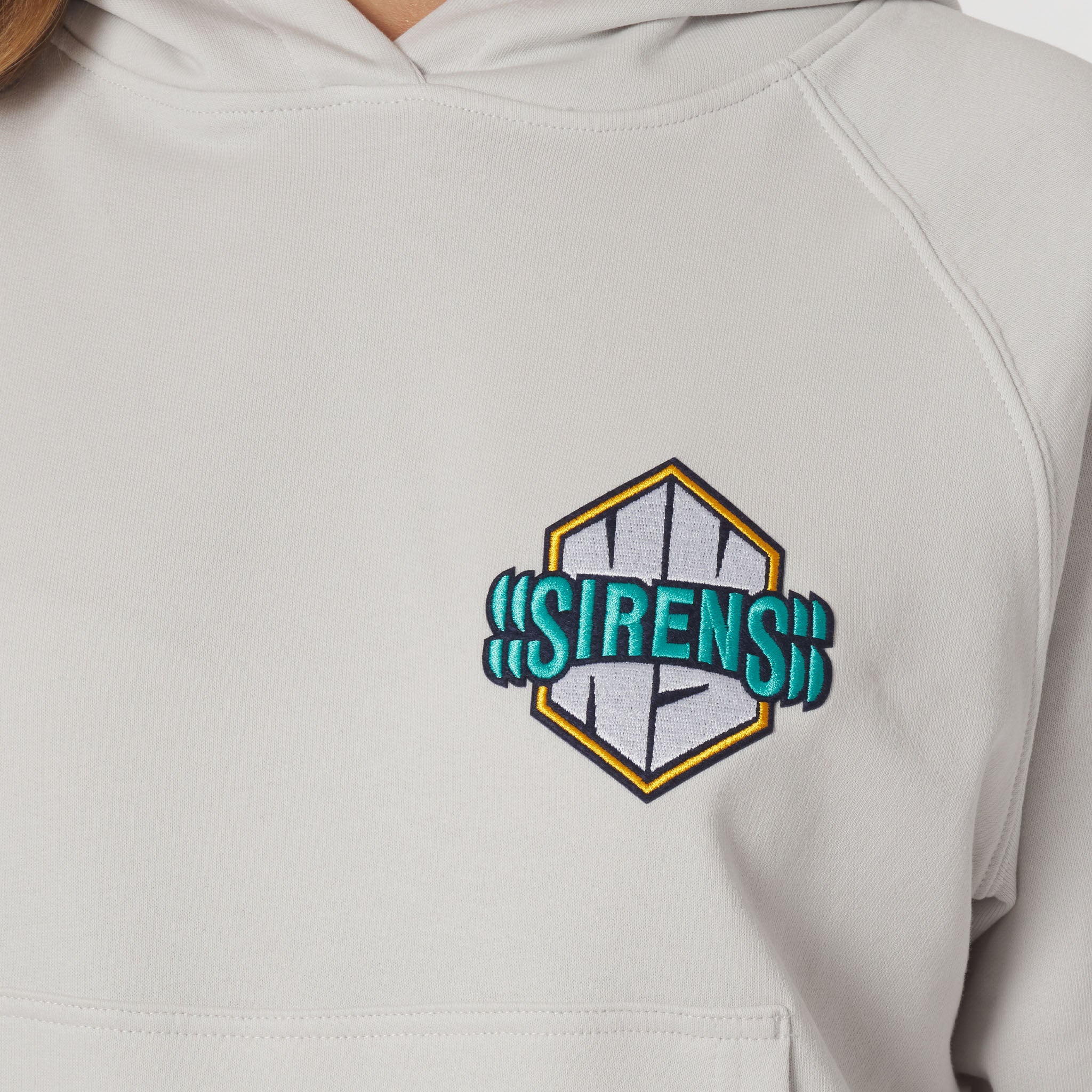 Gray hoodie with 'SIRENS' logo on a plain background