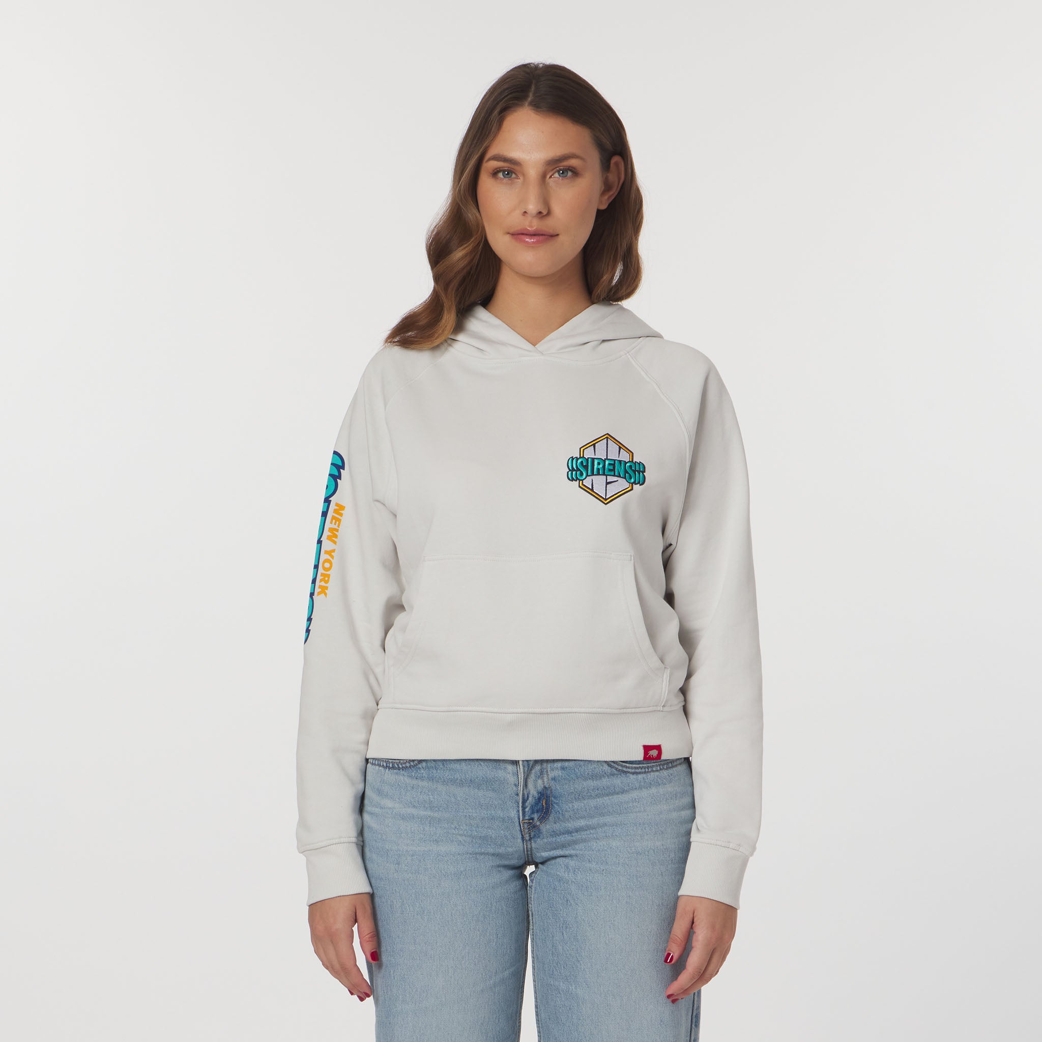 Woman wearing a light gray hoodie with branding on a white background