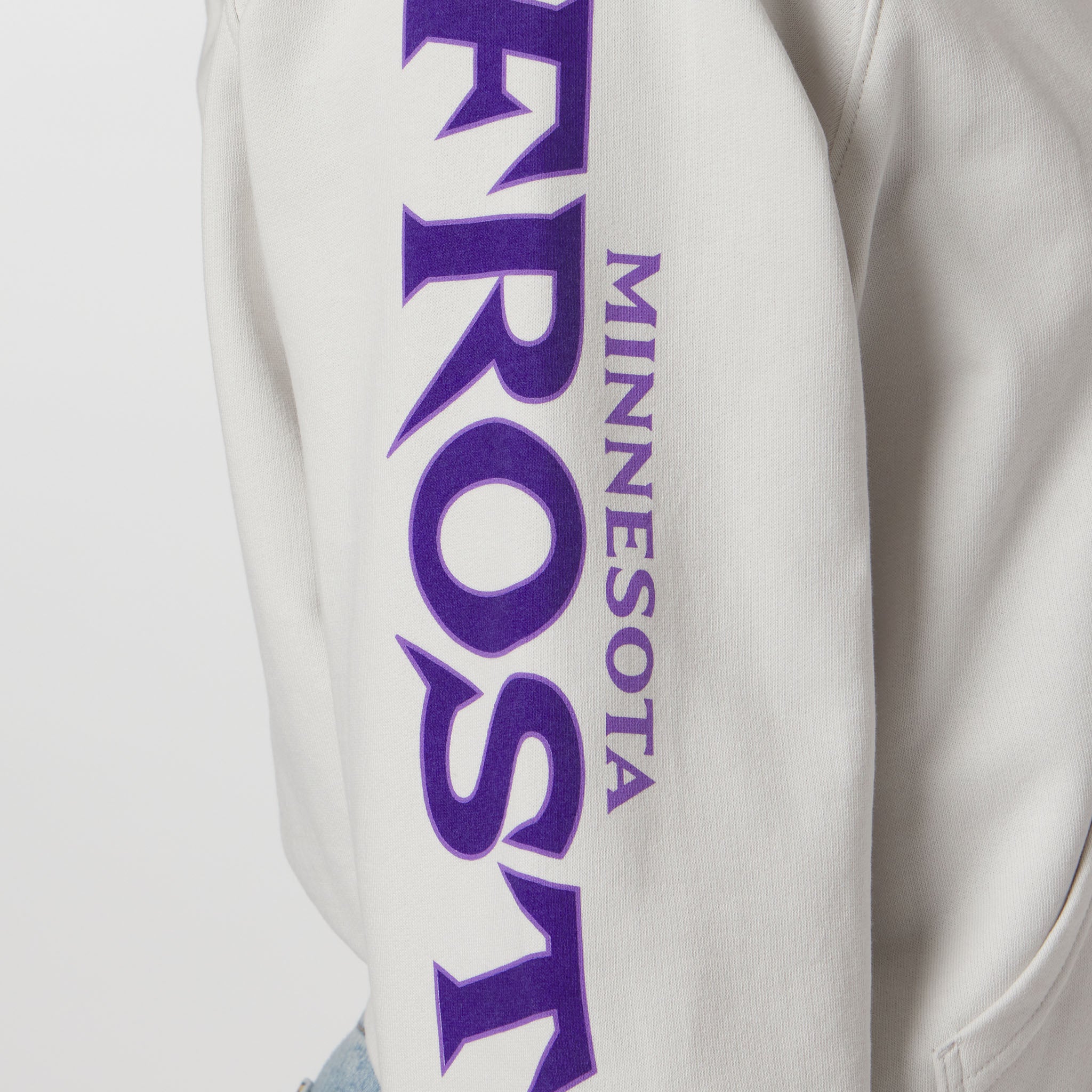 White sweatshirt sleeve with purple 'MINNESOTA FROST' text on a white background