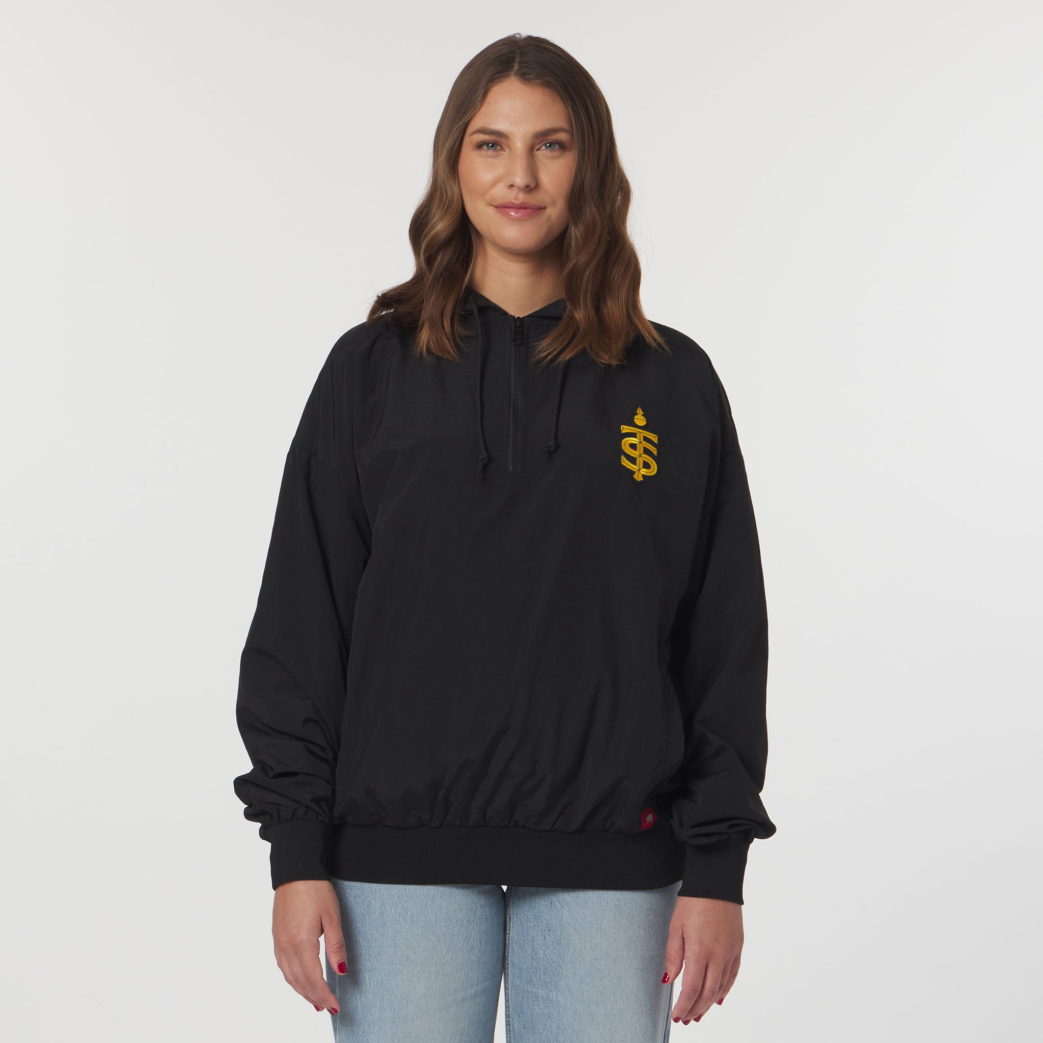 Person wearing a black hoodie with a yellow logo on a white background