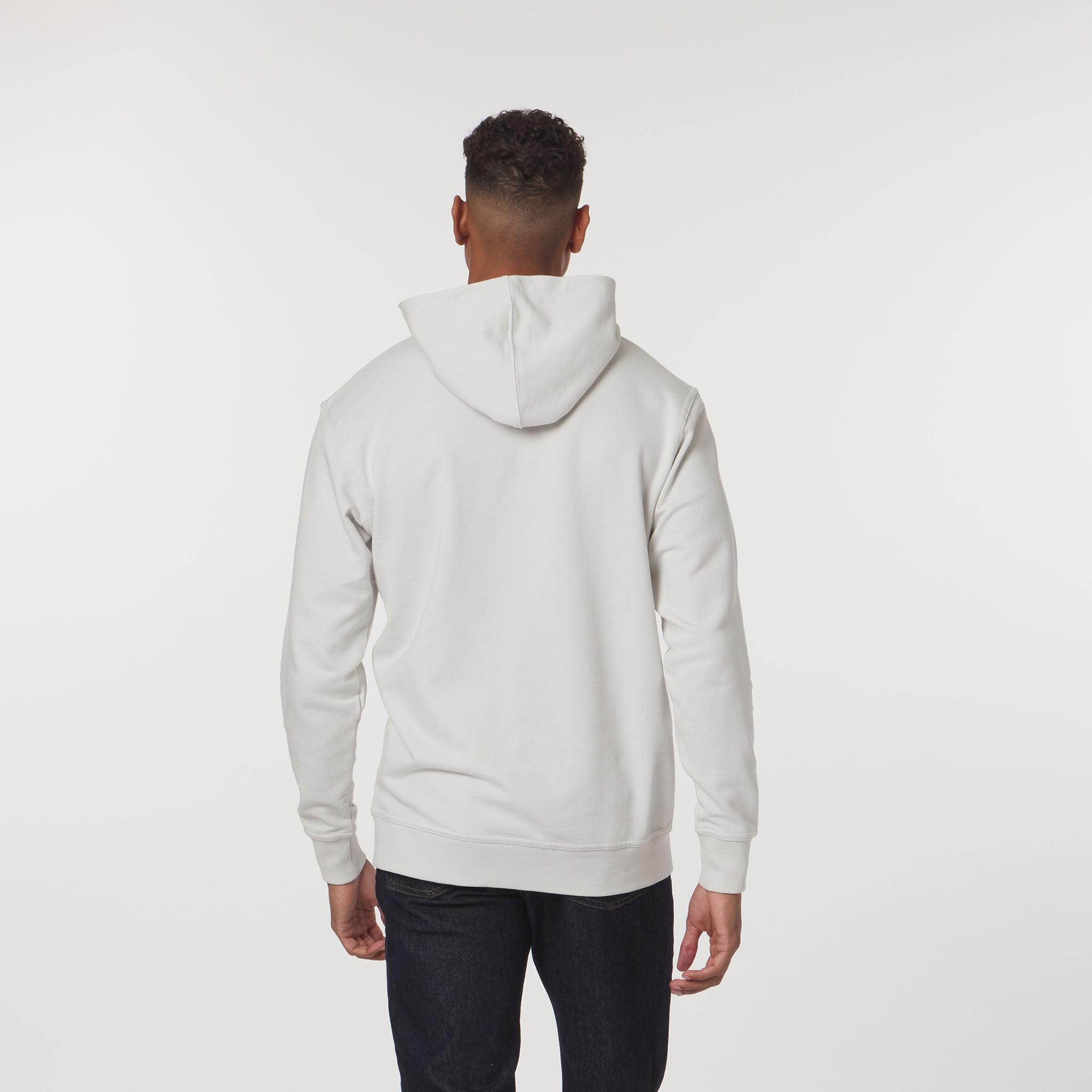 Person wearing a light gray hoodie on a white background