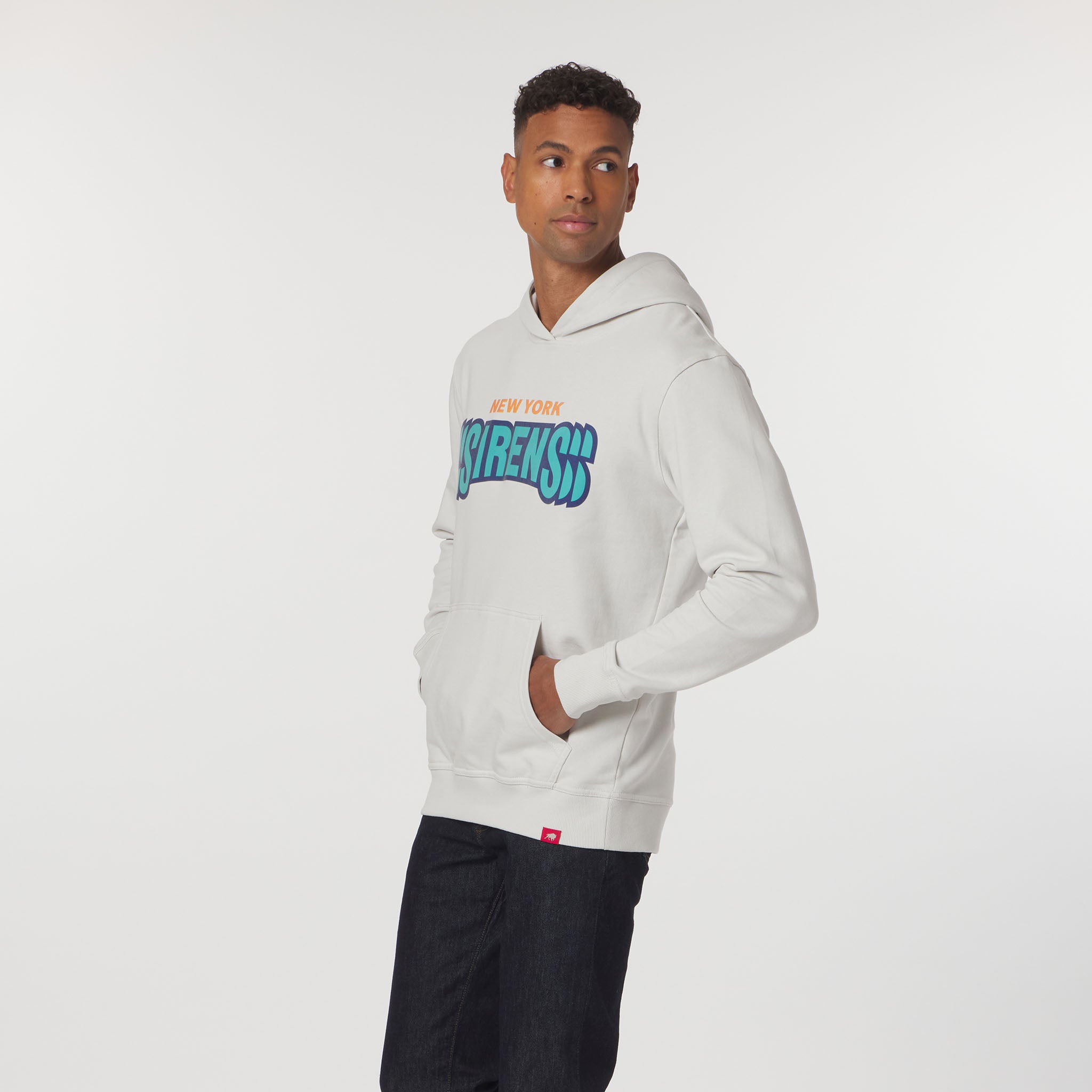 Person wearing a light gray hoodie with colorful text on a white background
