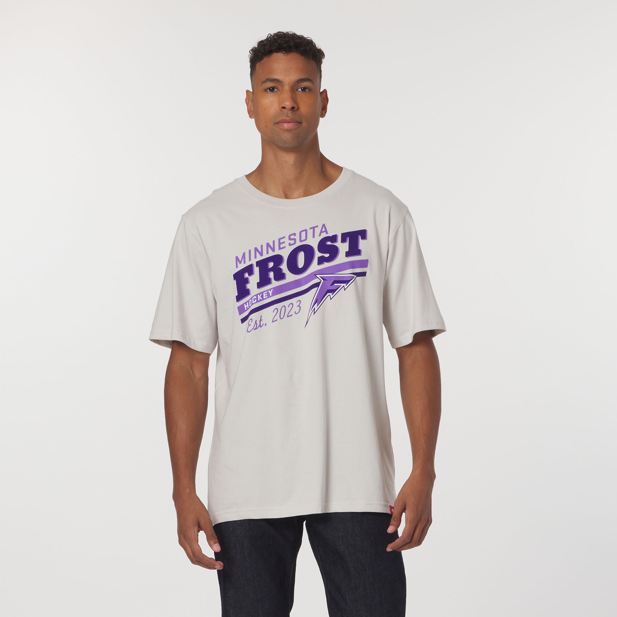 Person wearing a white t-shirt with 'Minnesota Frost' text on a plain background