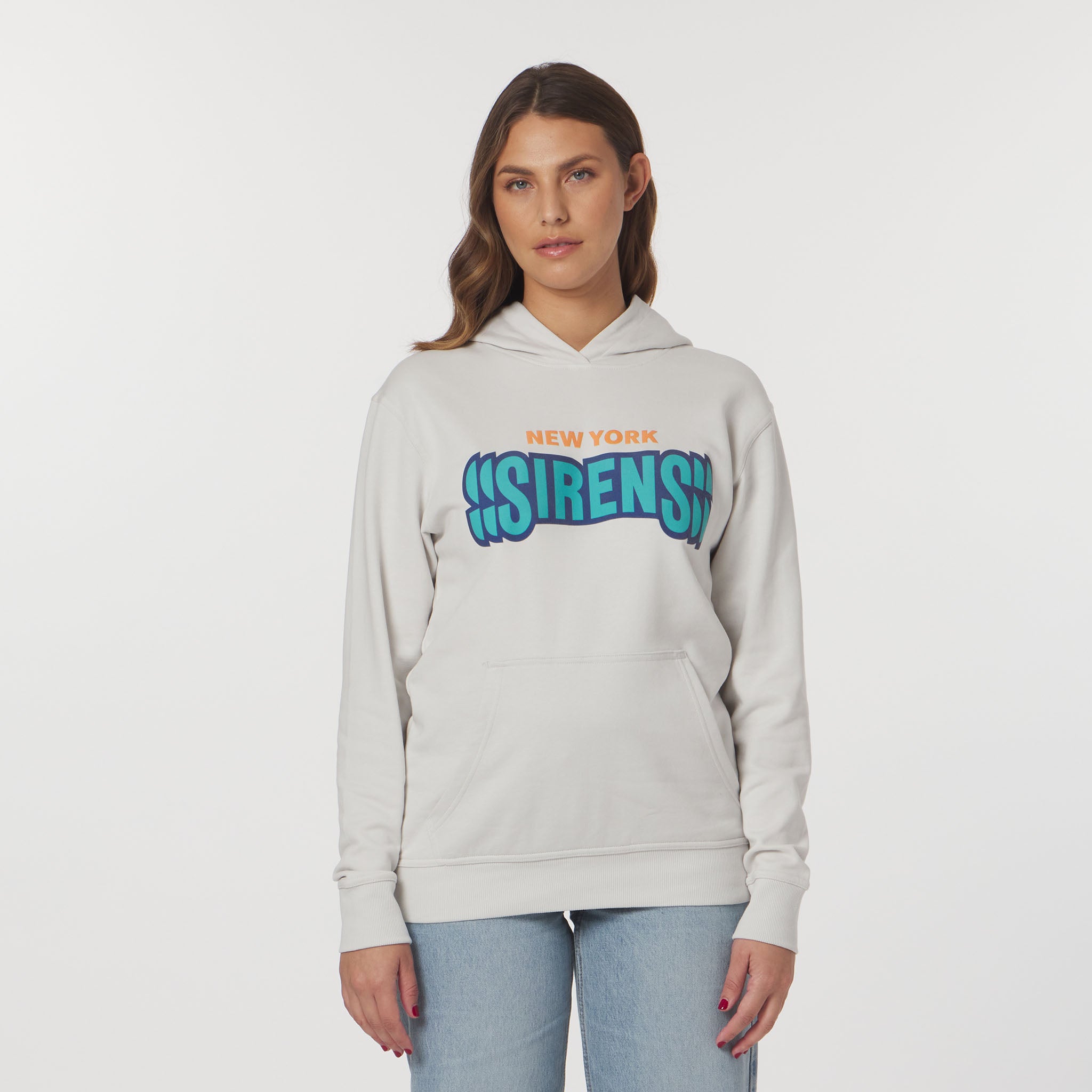 Woman wearing a light gray hoodie with colorful text on a white background