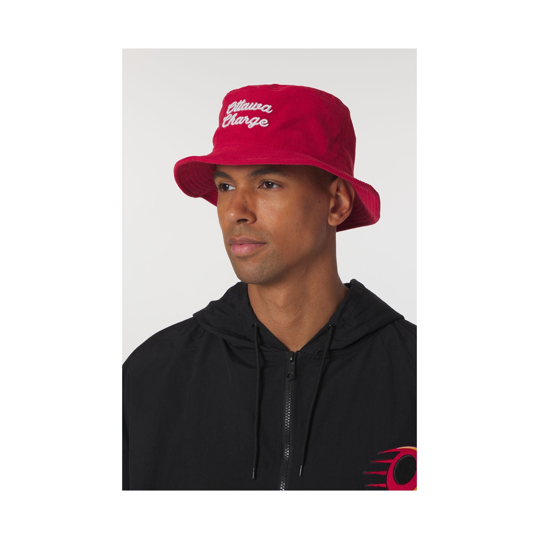 Person wearing a red bucket hat with white text on a plain background