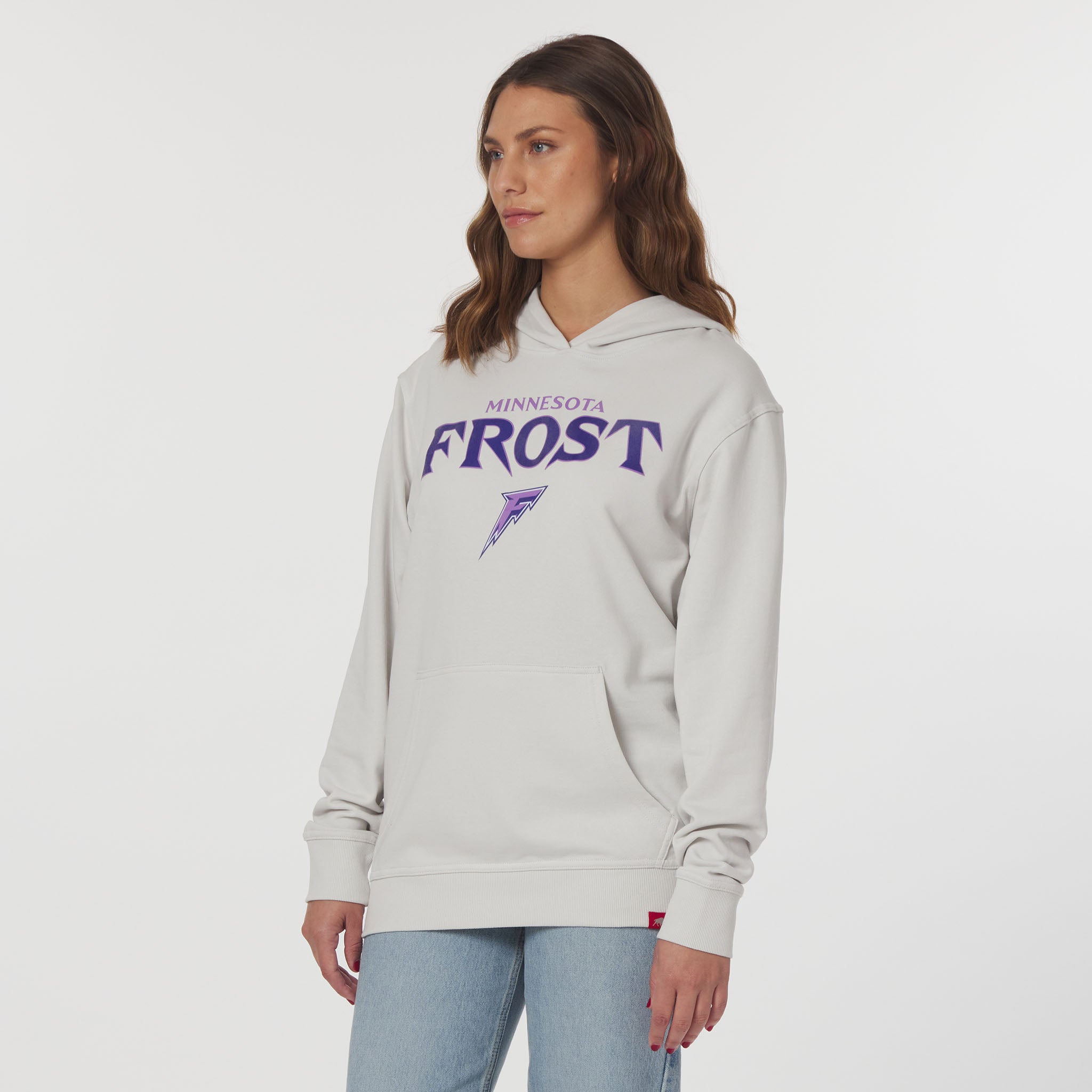 Woman wearing a gray hoodie with 'Minnesota Frost' text on a white background
