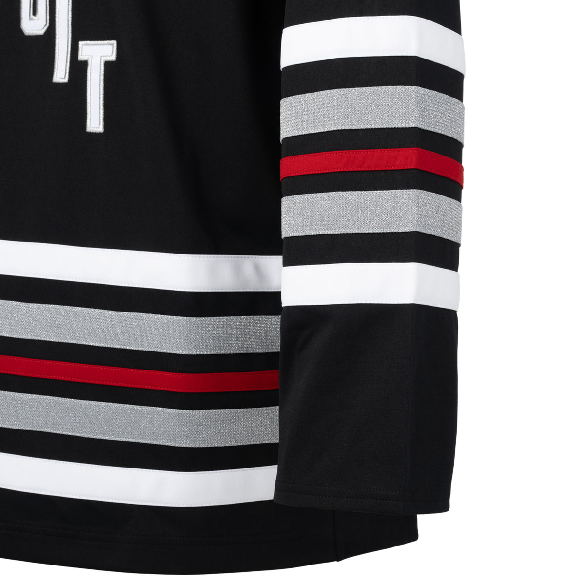 Front of a black jersey with red, white, and shimmering silver stripes on the sleeves and bottom hem. 'DETROIT' is in white with silver outlining diagonally across the chest.