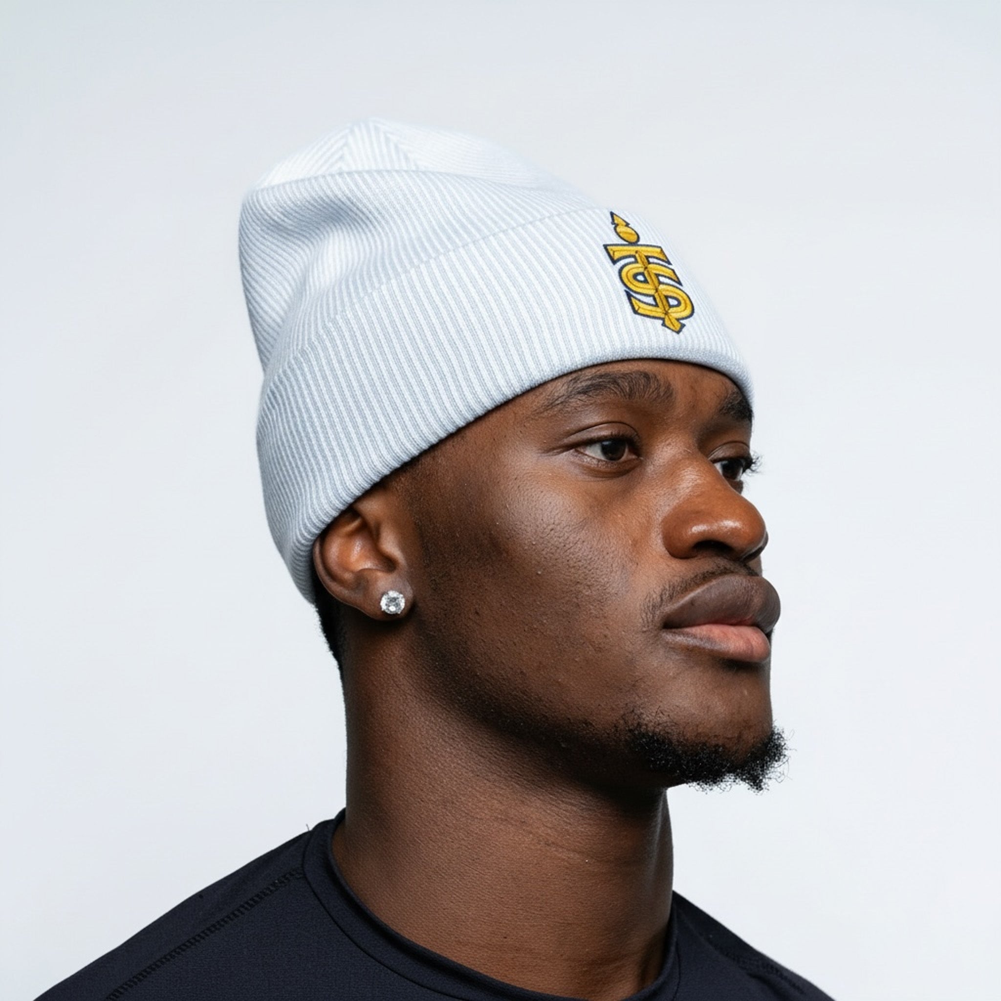 Person wearing a white beanie with a logo on a plain background