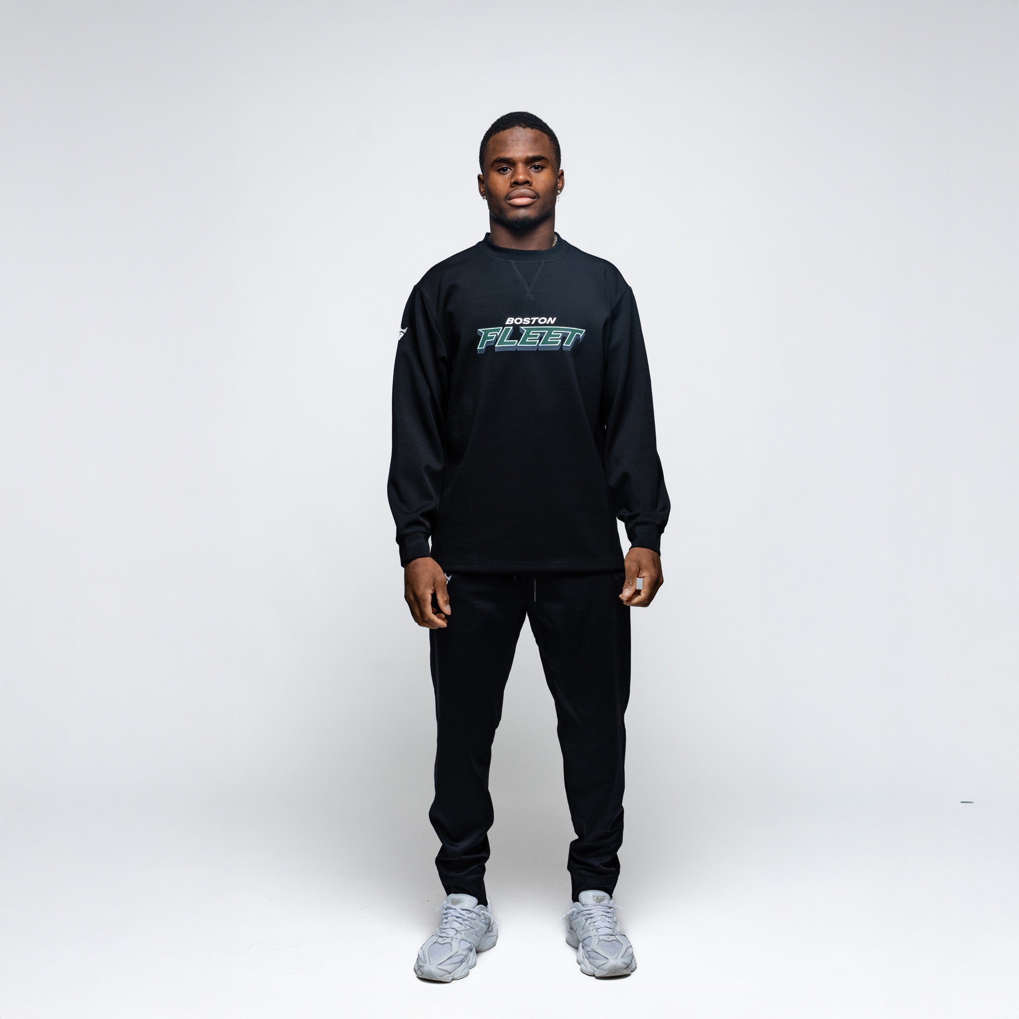 Person wearing a black sweatshirt with text on a white background