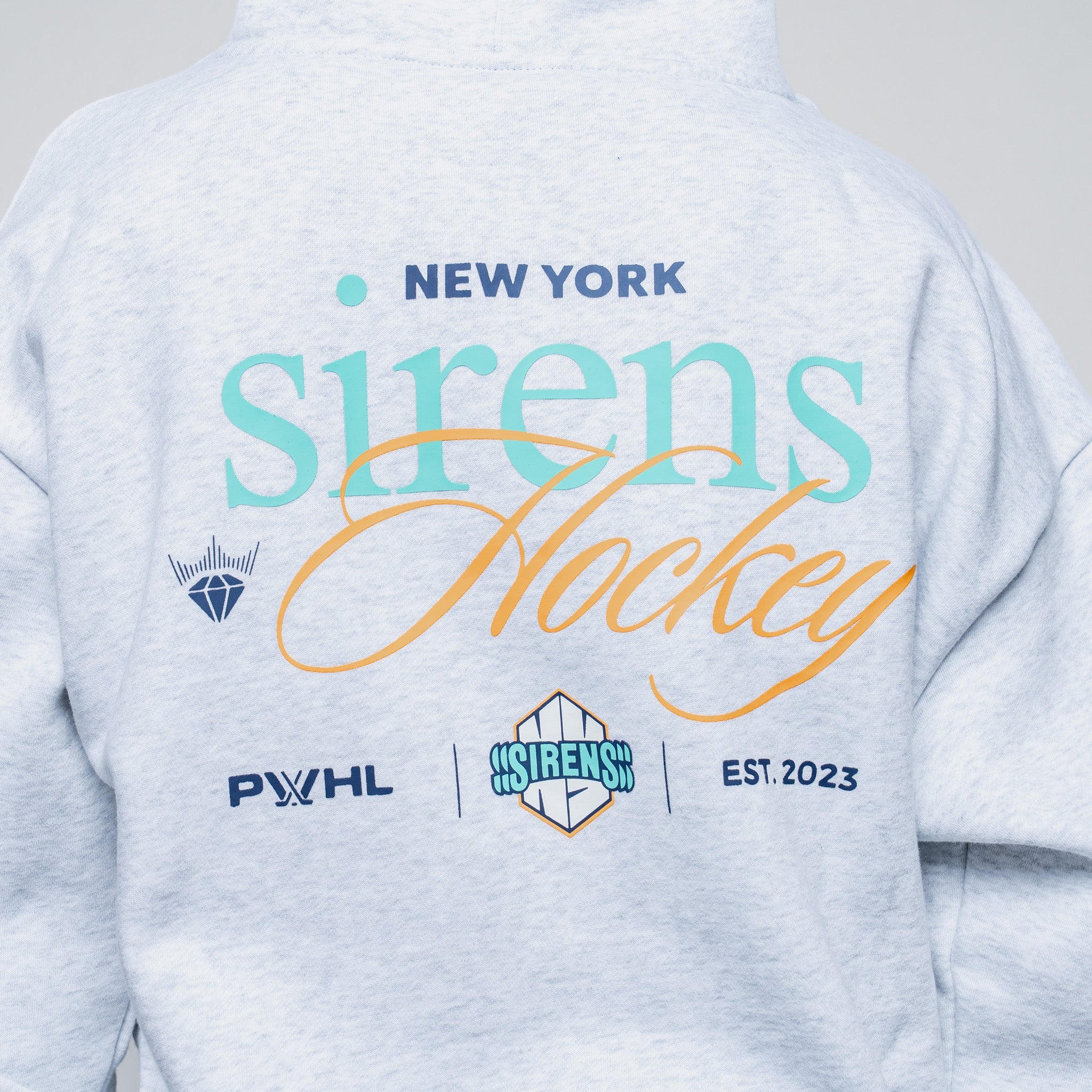 Gray sweatshirt with 'New York Sirens Hockey' text and logos on a plain background