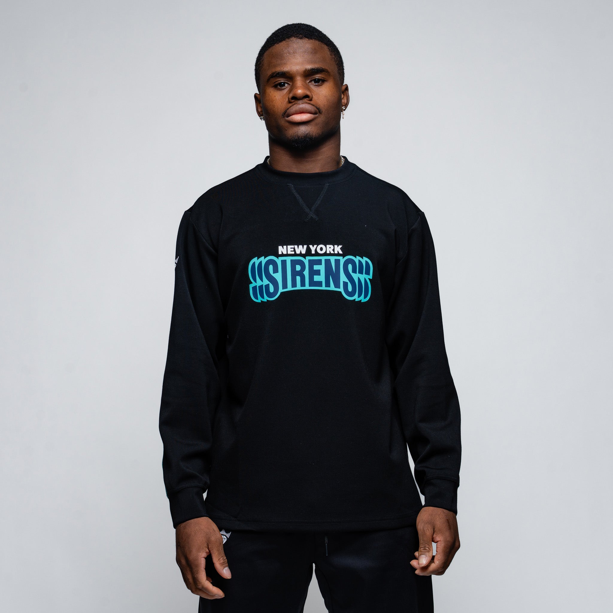 Person wearing a black sweatshirt with blue text on a plain background