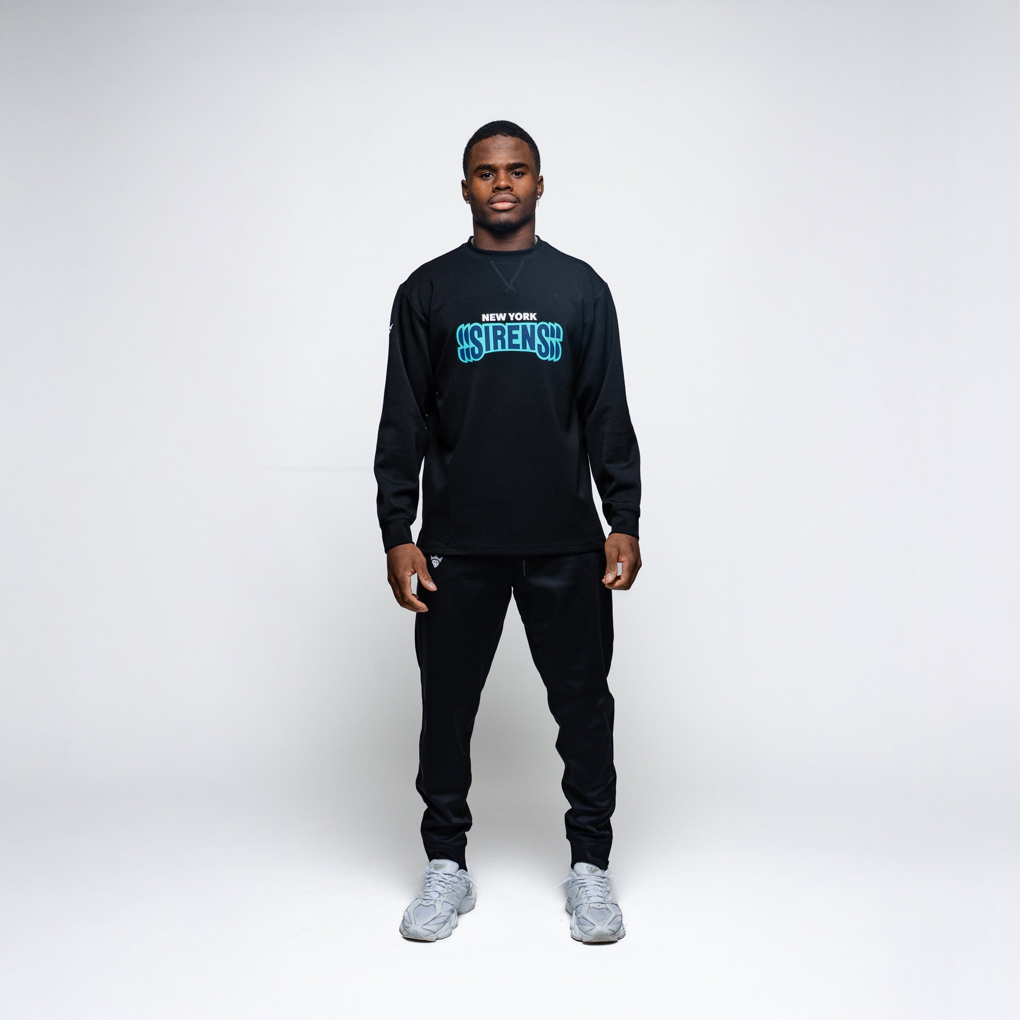 Person wearing a black sweatshirt with blue text on a white background