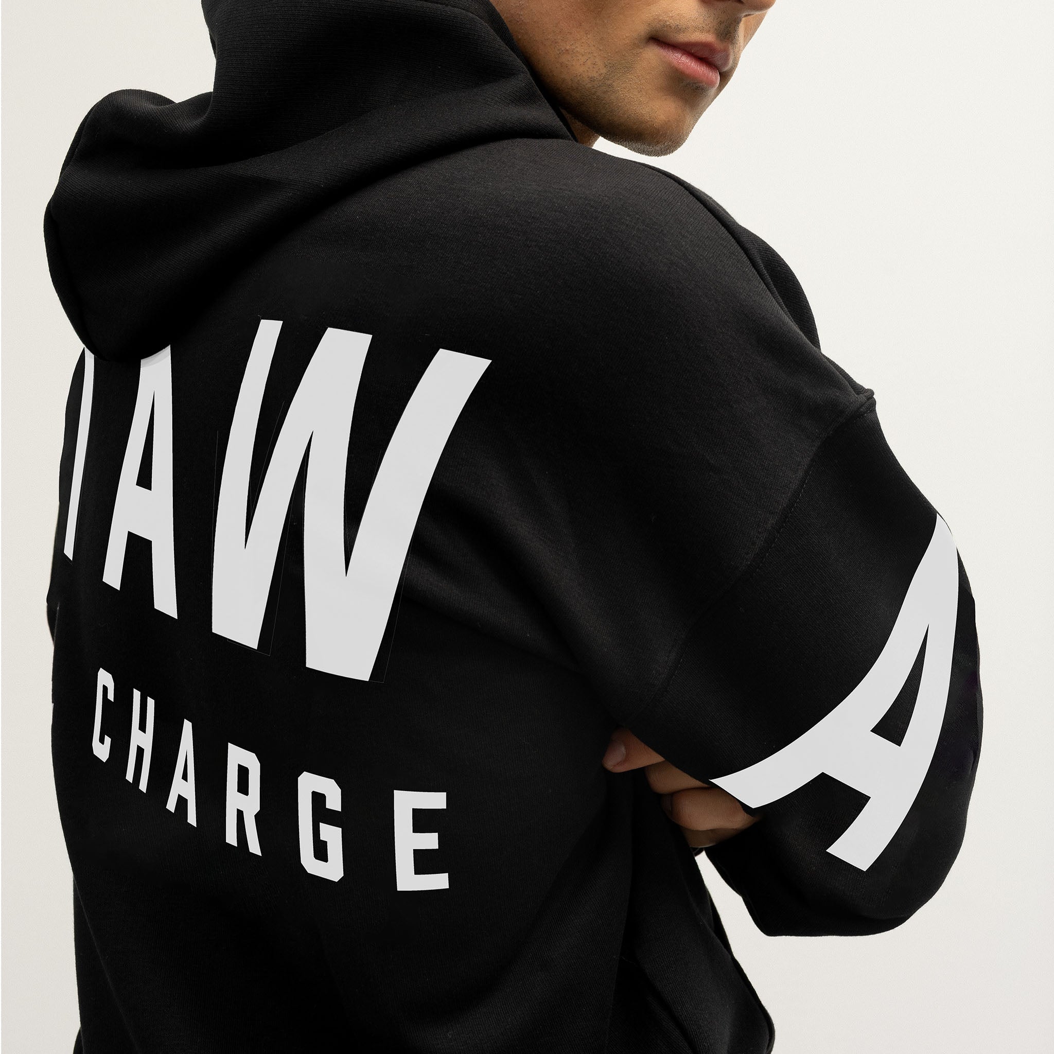 Black hoodie with white Ottawa Charge text and stripes on a plain background