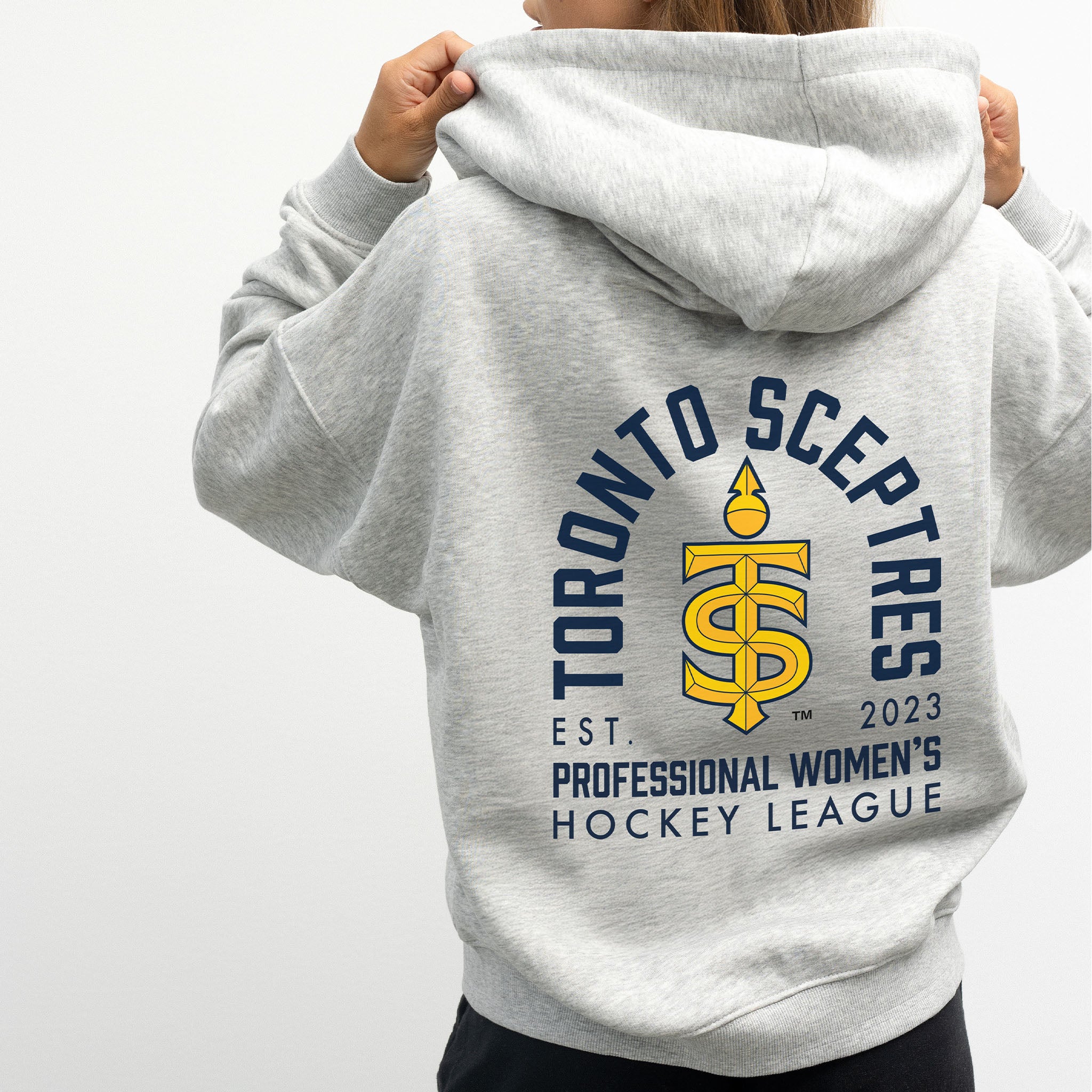 person wearing the Toronto Sceptres grey zip-up hoodie with a graphic design on the back