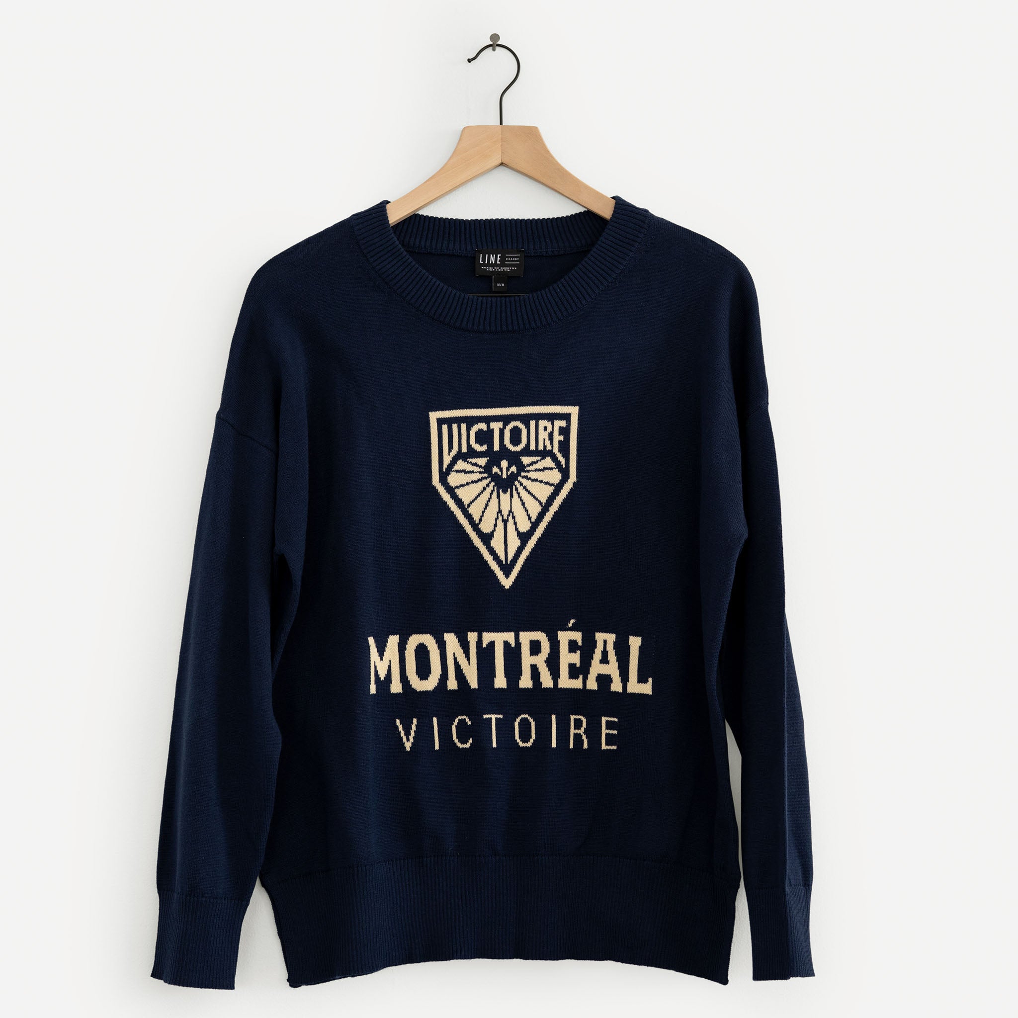Navy blue sweatshirt with 'Montreal Victoire' text and logo on a white background