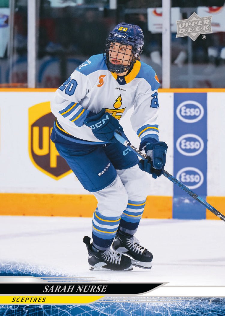 Hockey player in action on an ice rink with branding and logos in the background
