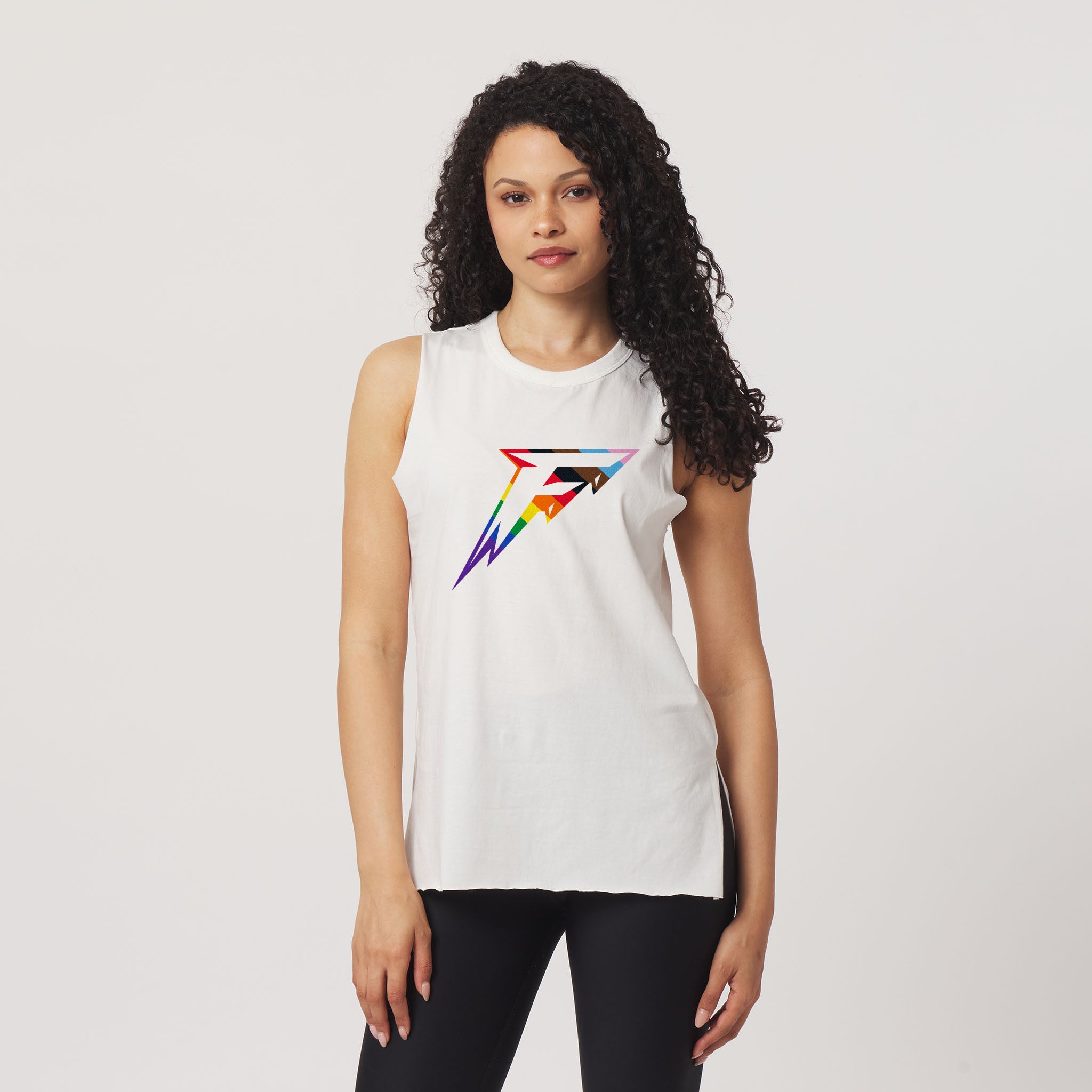 Woman wearing a white sleeveless shirt with a colorful logo on a plain background