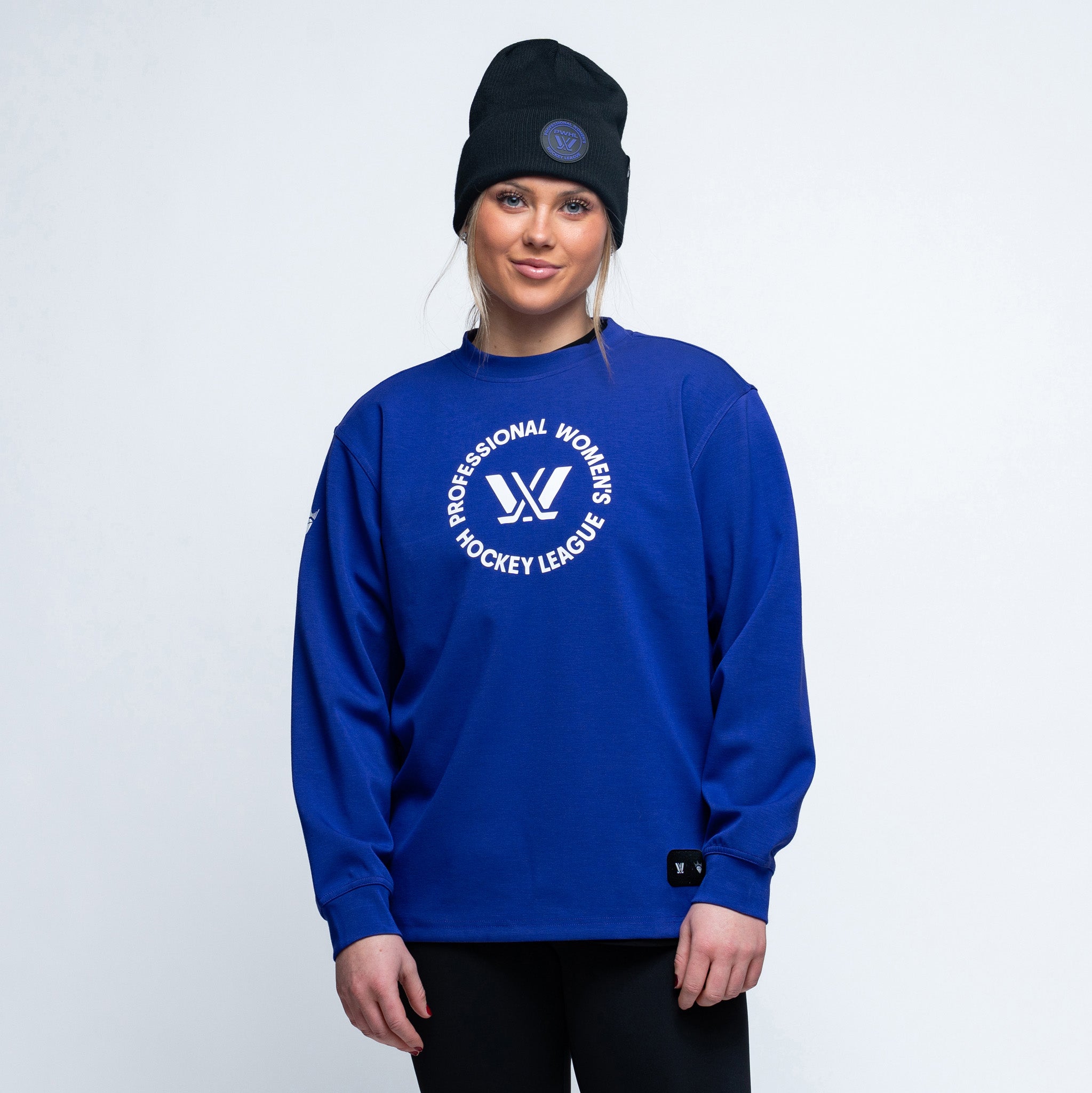 Person wearing a purple sweatshirt with a logo on a white background