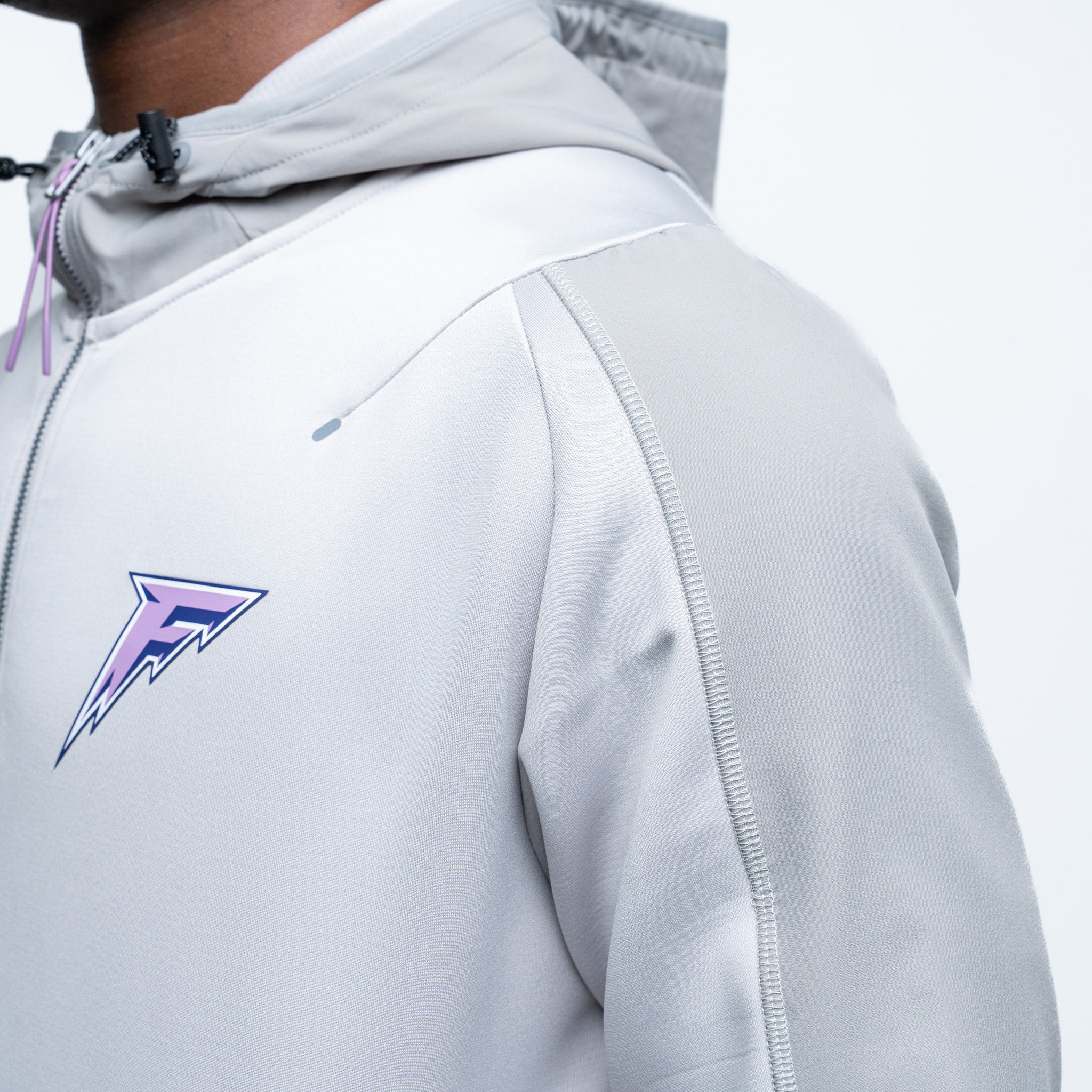 Gray jacket with a logo on the chest against a white background