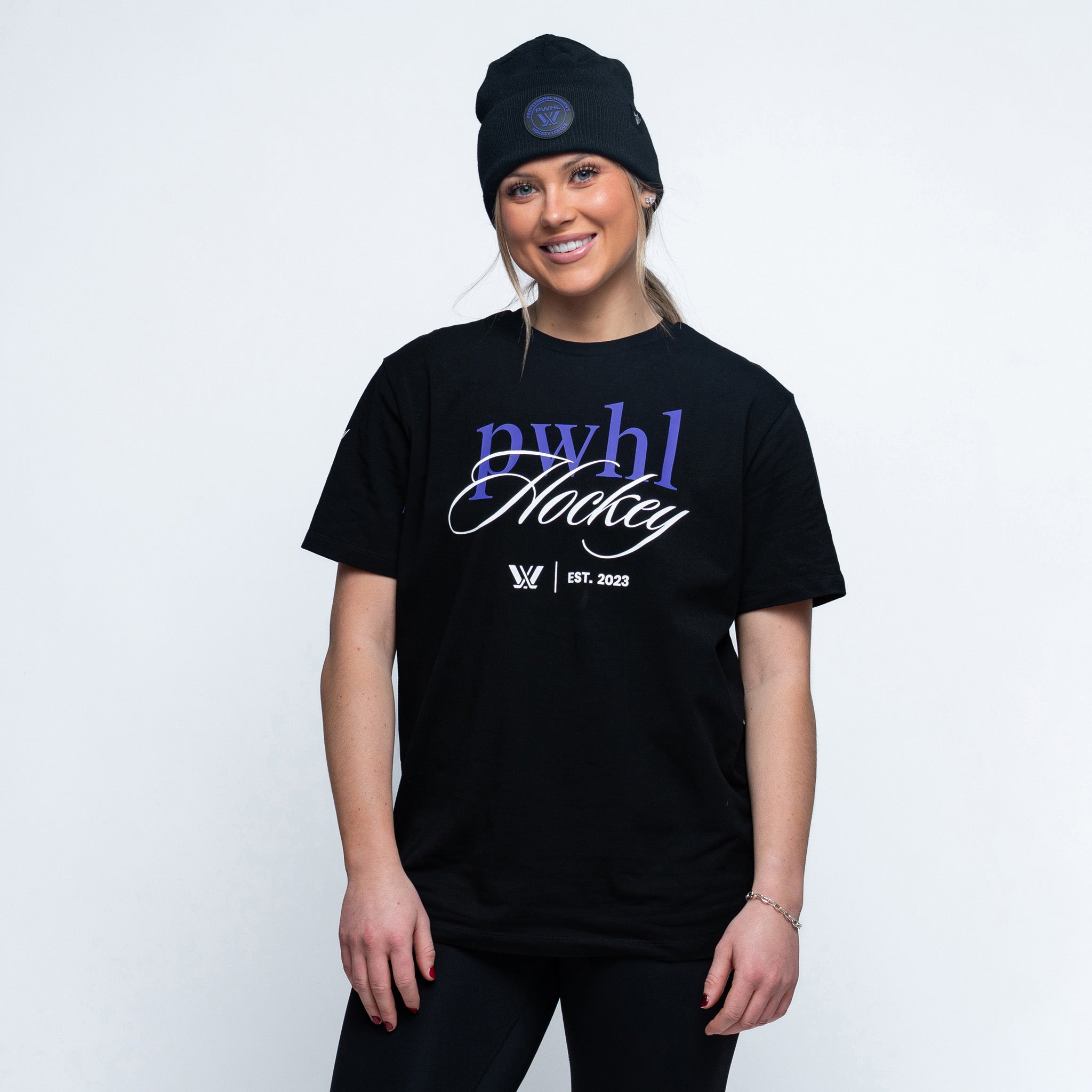 Person wearing a black tshirt with "PWHL Hockey" text, the PWHL logo, and EST. 2023 graphic