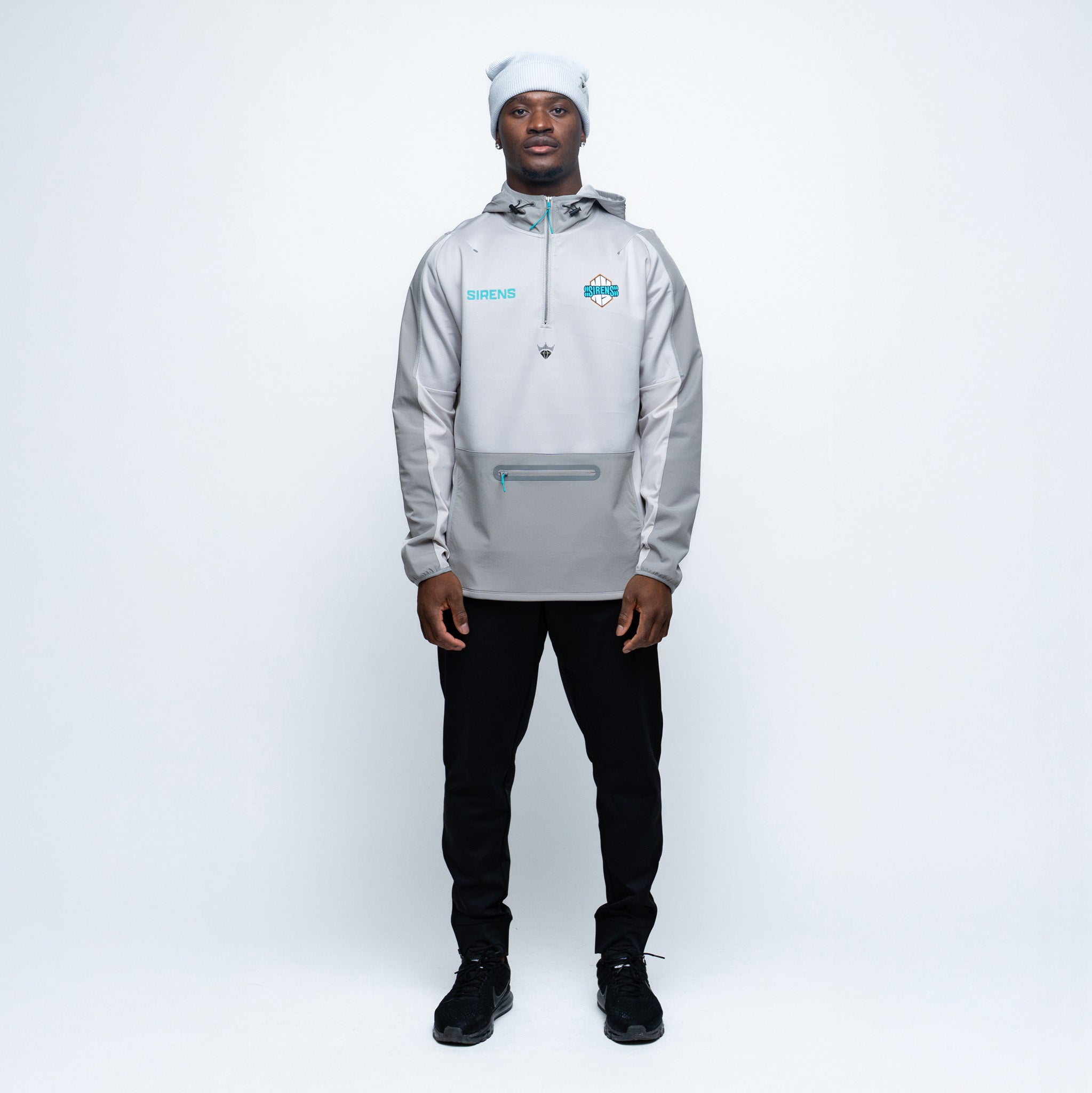 Person wearing a light gray hoodie with a brand logo on a white background