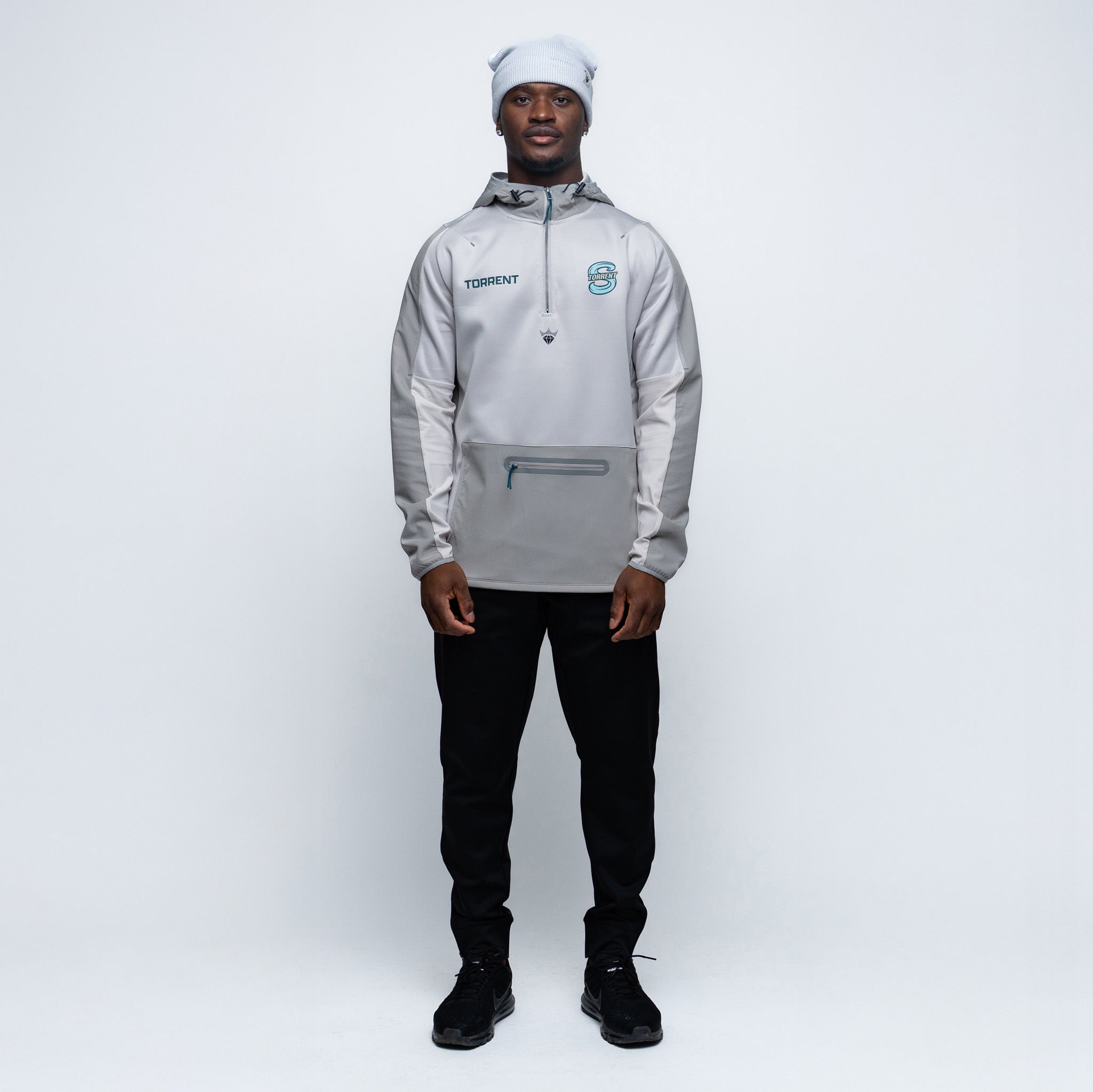 Person wearing a gray jacket with a brand logo on a white background