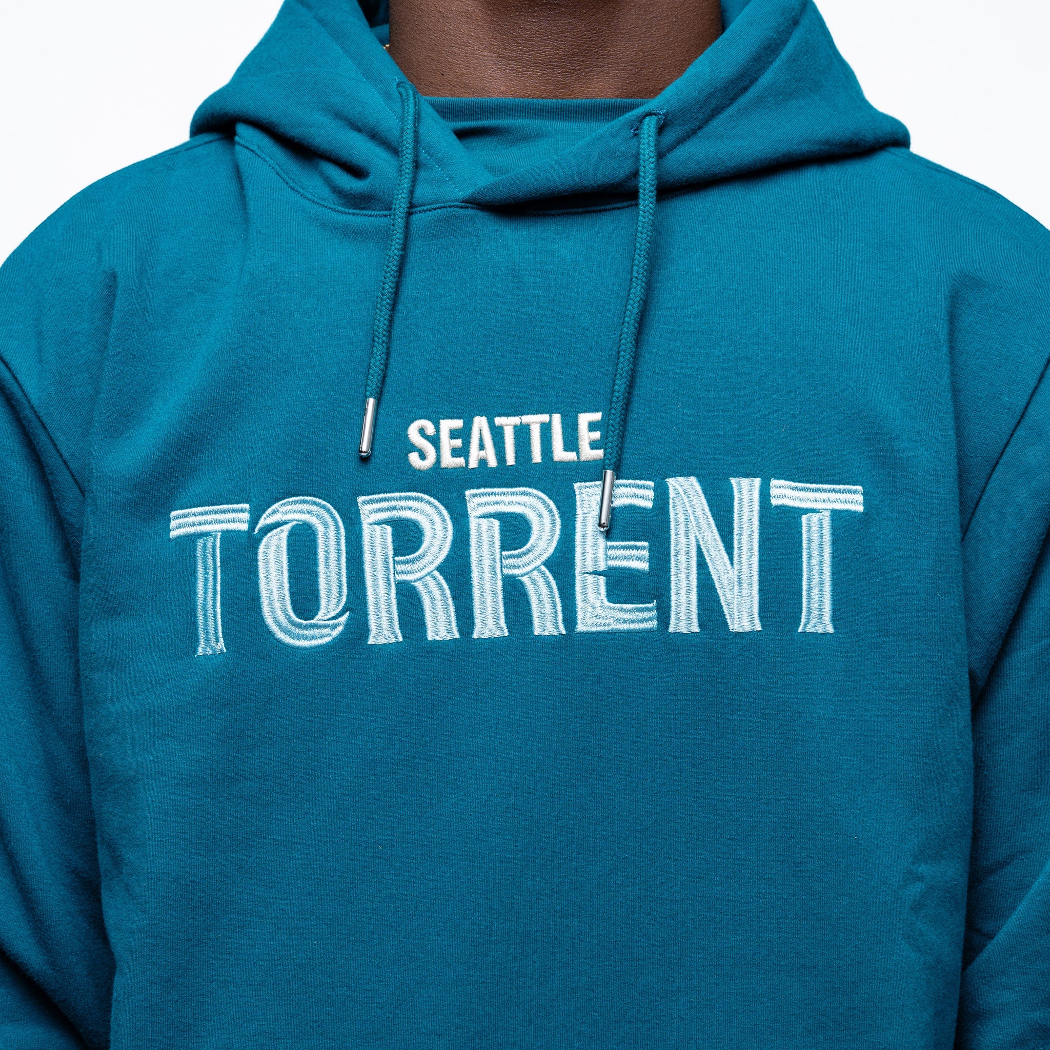 Close up on the embroidery on the green Adult Seattle Torrent Royalty Heritage Cloud Hoodie