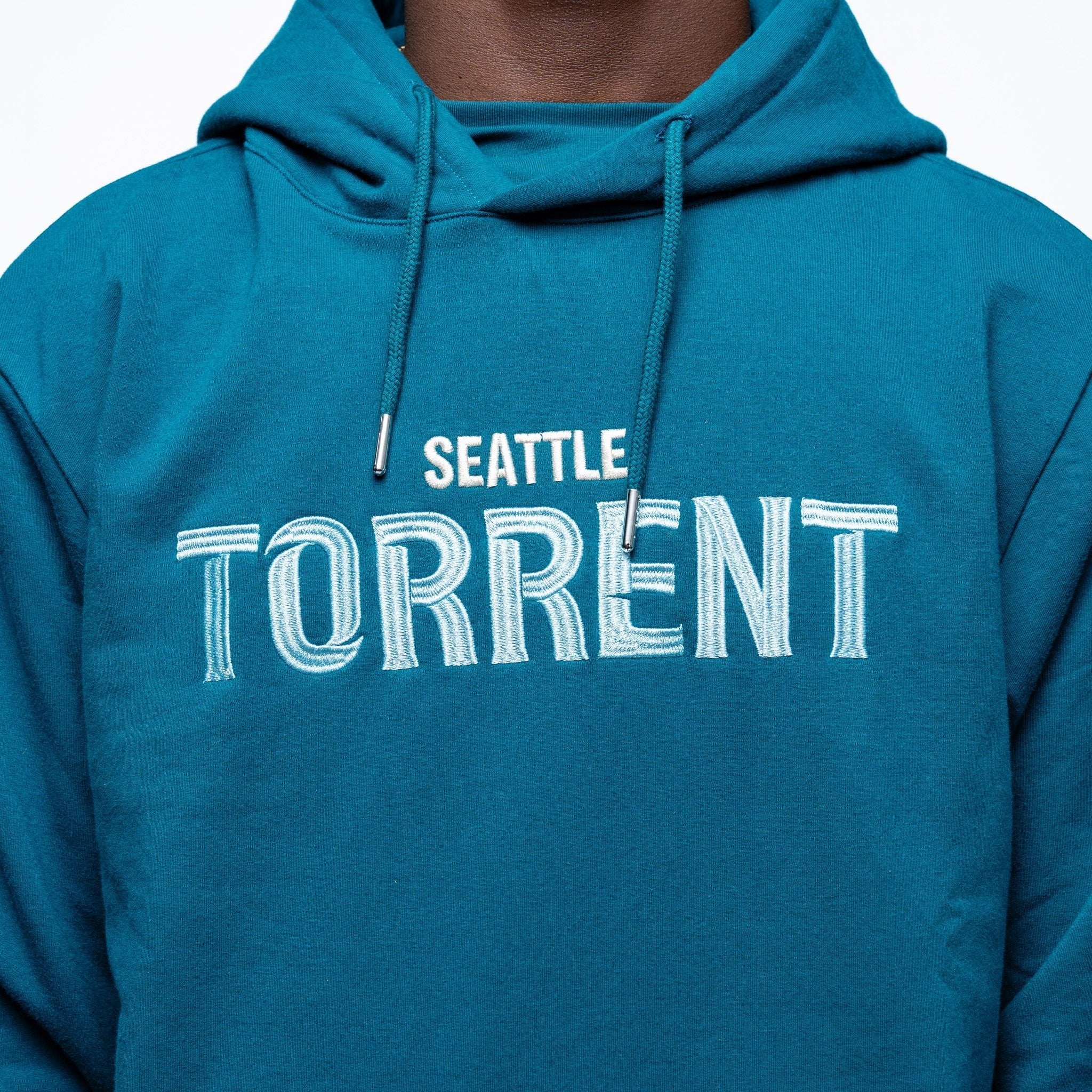 Close up on the embroidery on the green Adult Seattle Torrent Royalty Heritage Cloud Hoodie
