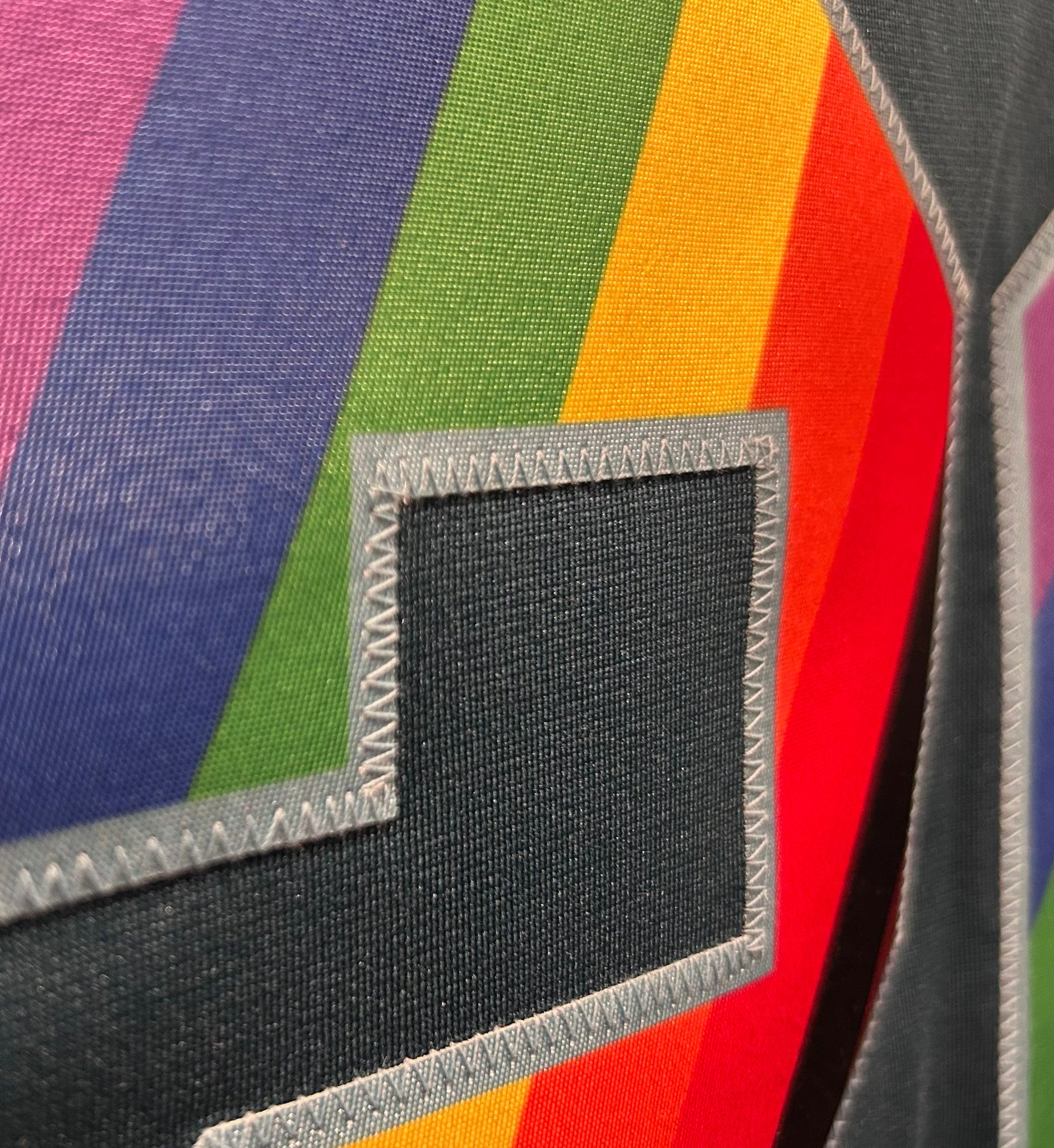 Close-up of a multicolored striped fabric with a black label.