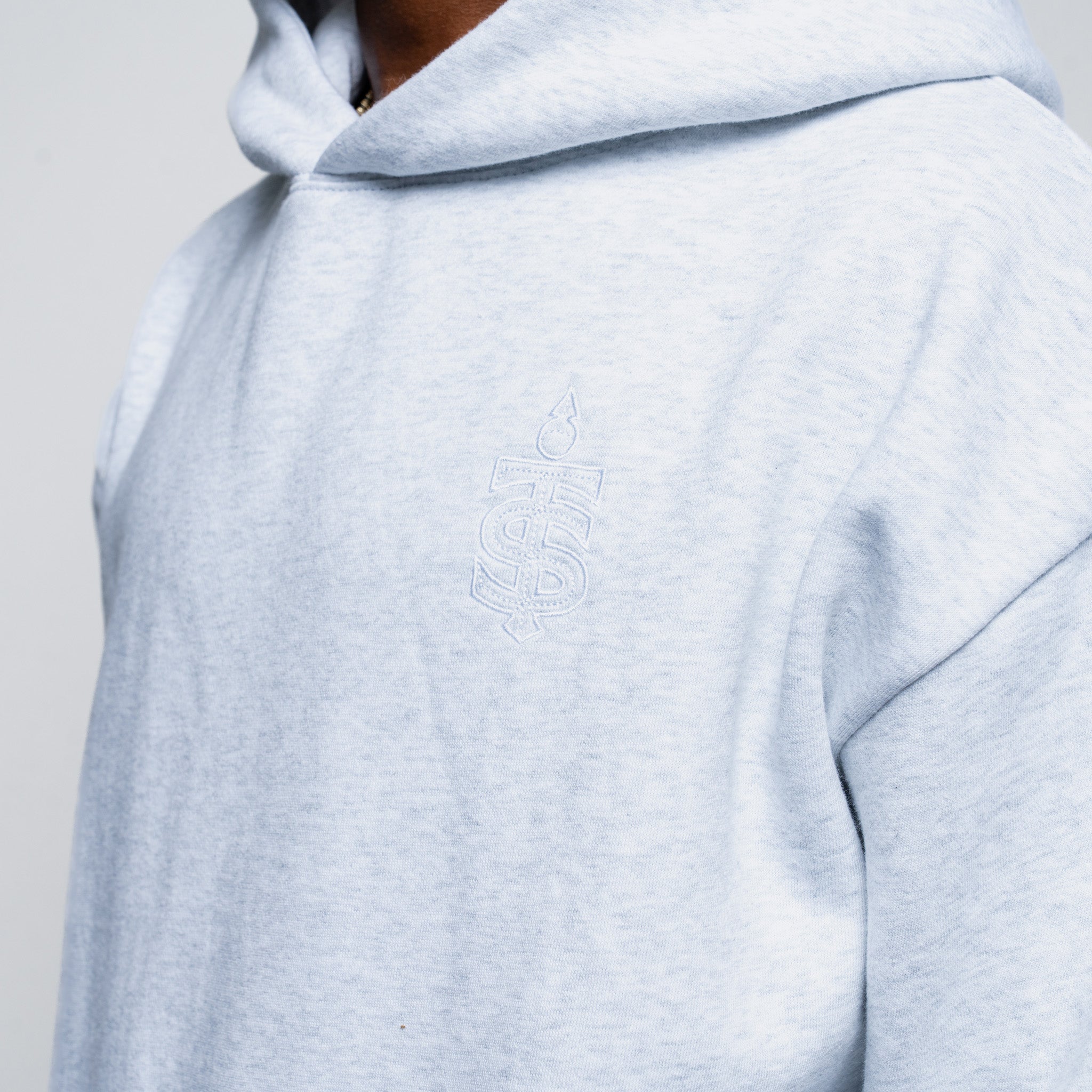 Light gray hoodie with a brand logo on a plain background