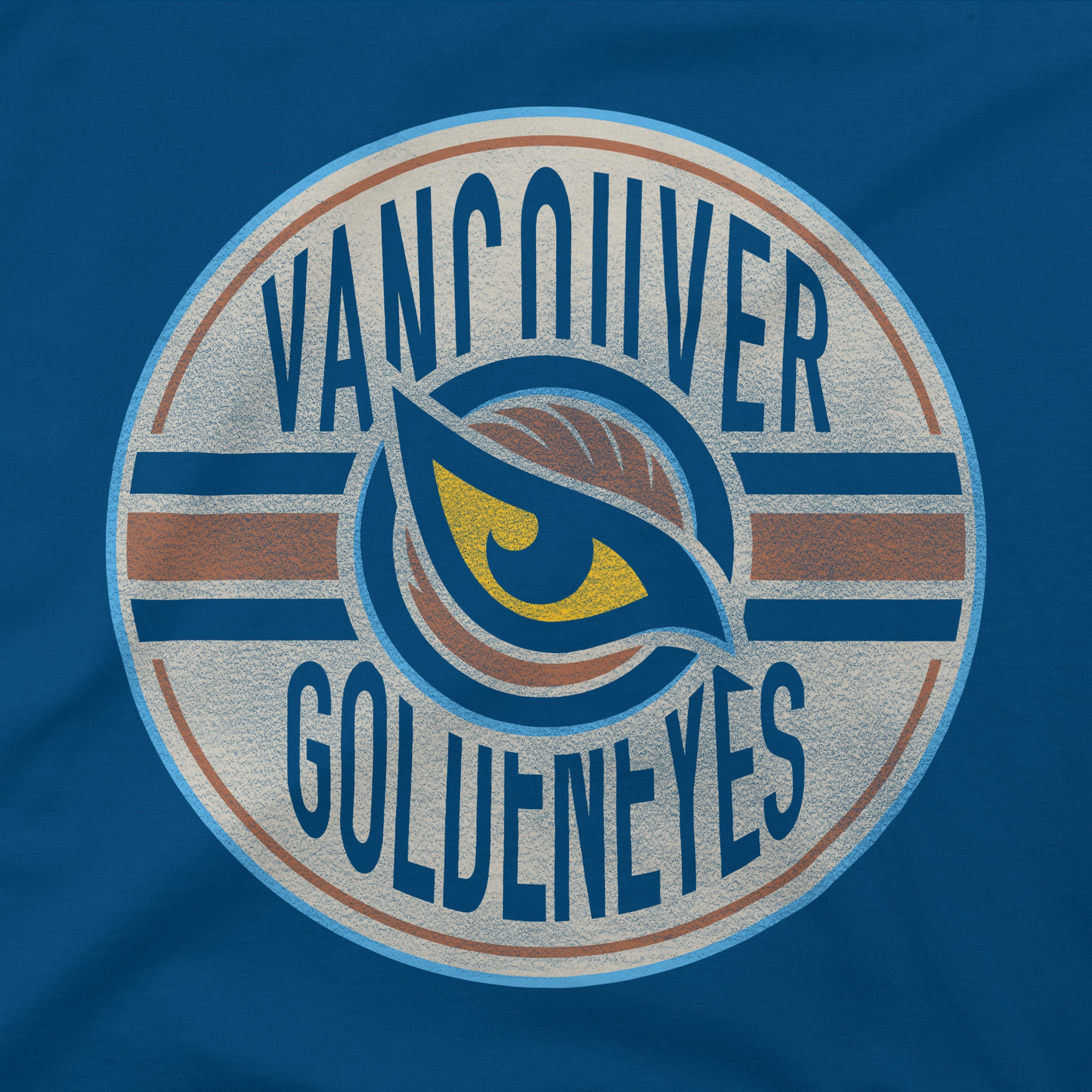Close up of the Vancouver Goldeneyes graphic on the Blue Adult Vancouver Goldeneyes Stadium Essentials Seal T-Shirt