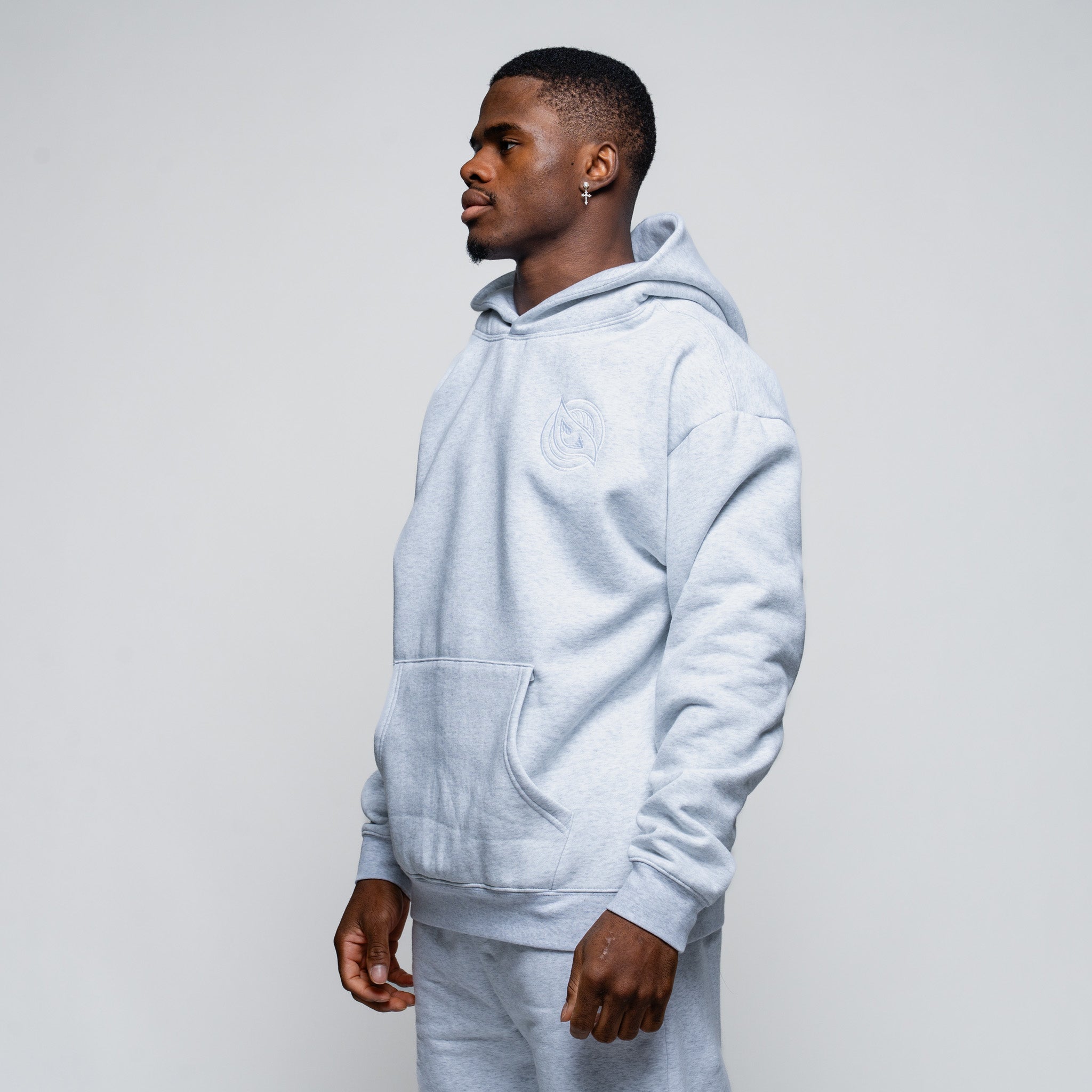 Man wearing a light blue hoodie against a plain background