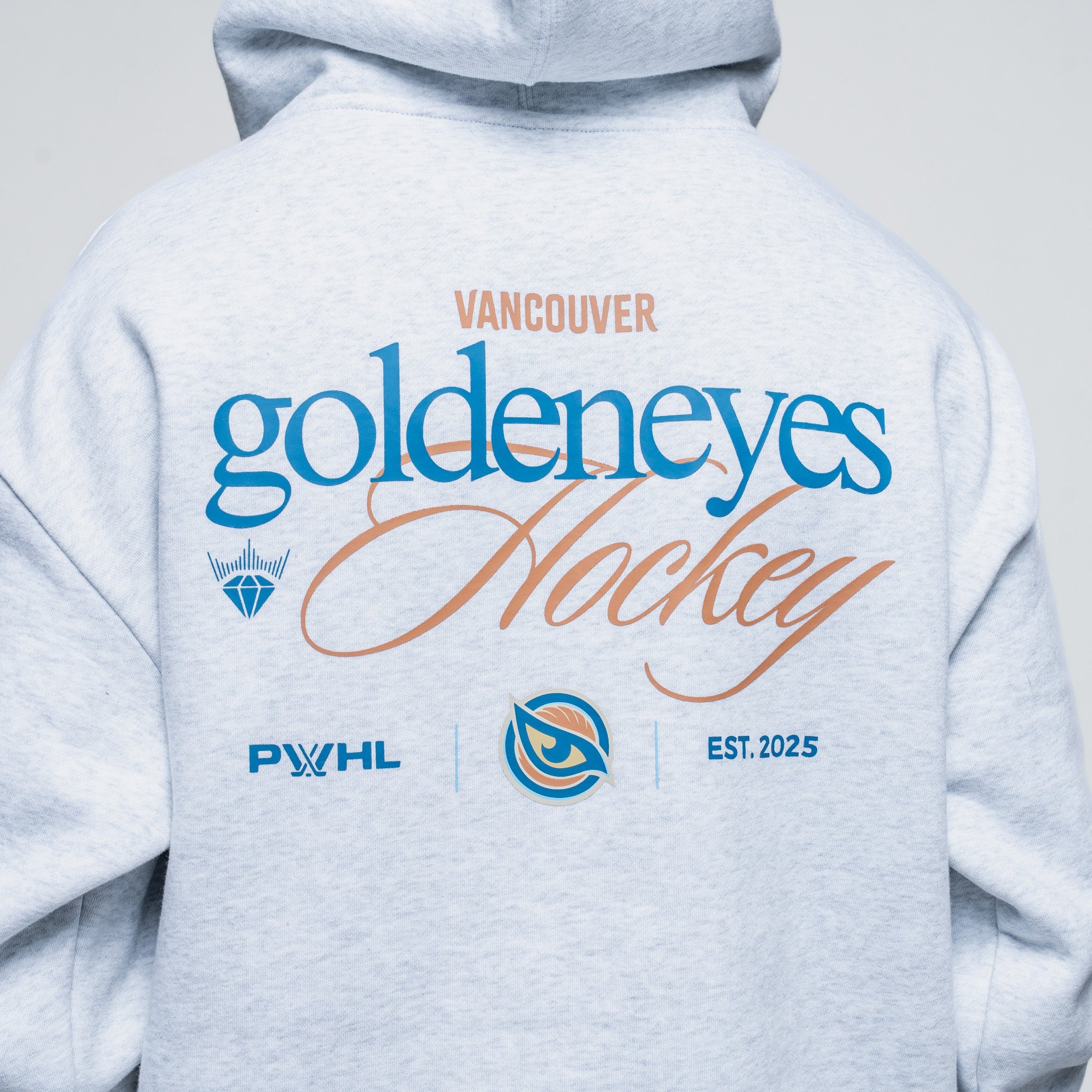Light gray hoodie with 'Vancouver Goldeneyes Hockey' text and logos on the back.
