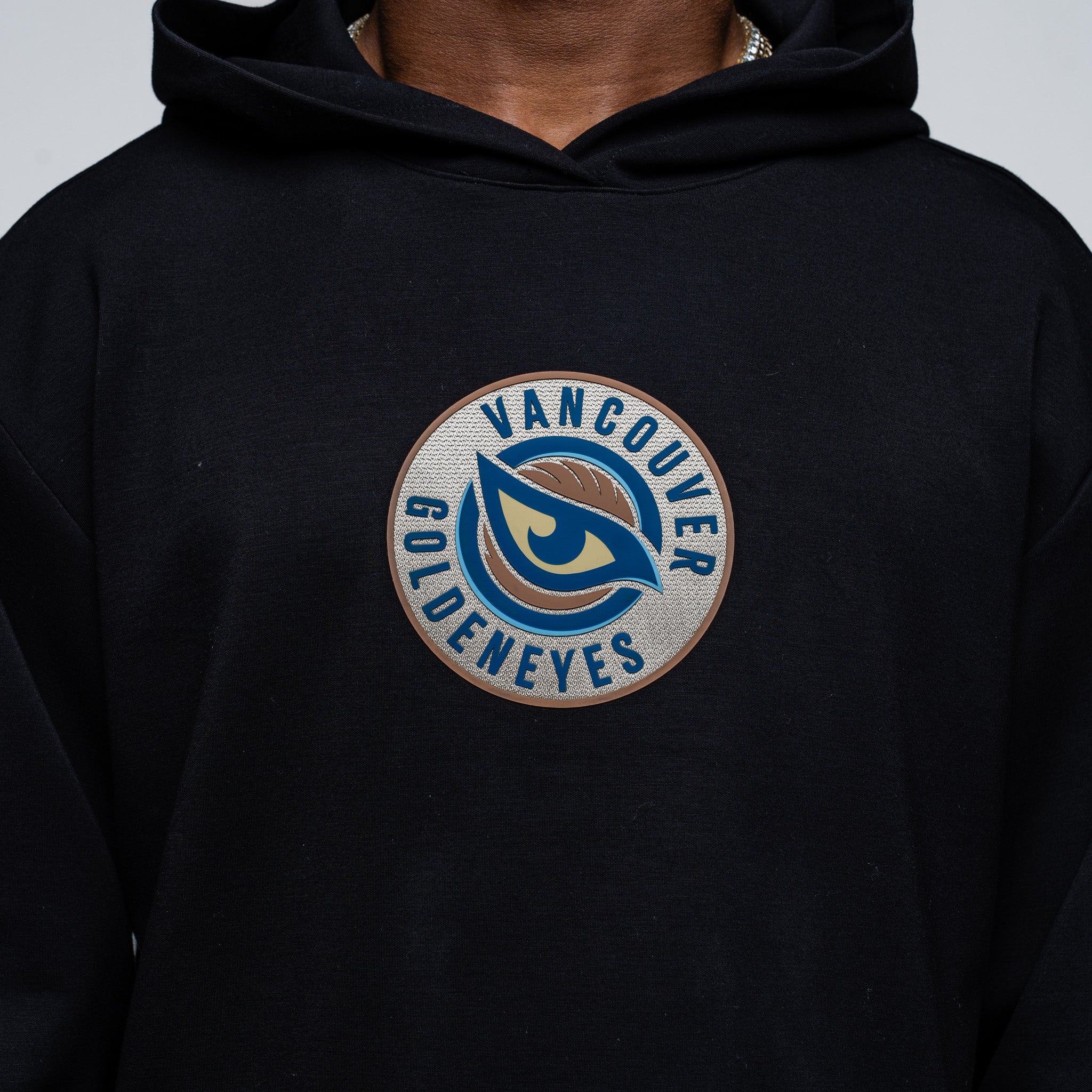 Black hoodie with 'Vancouver Goldeneyes' logo on a gray background