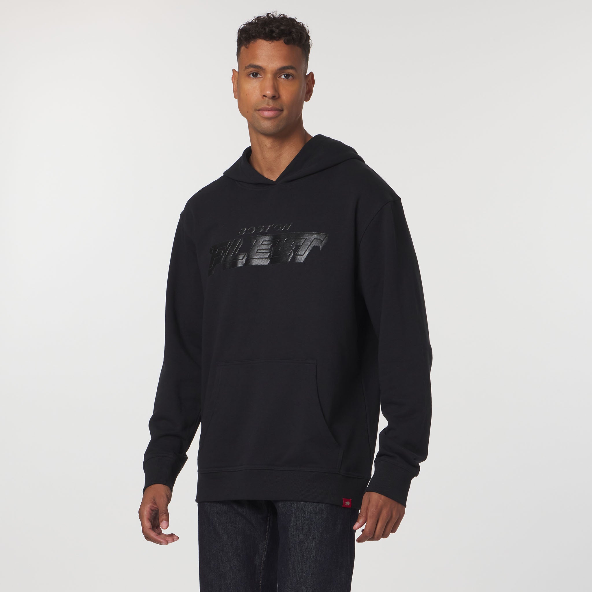 Man wearing a black hoodie with text on a white background