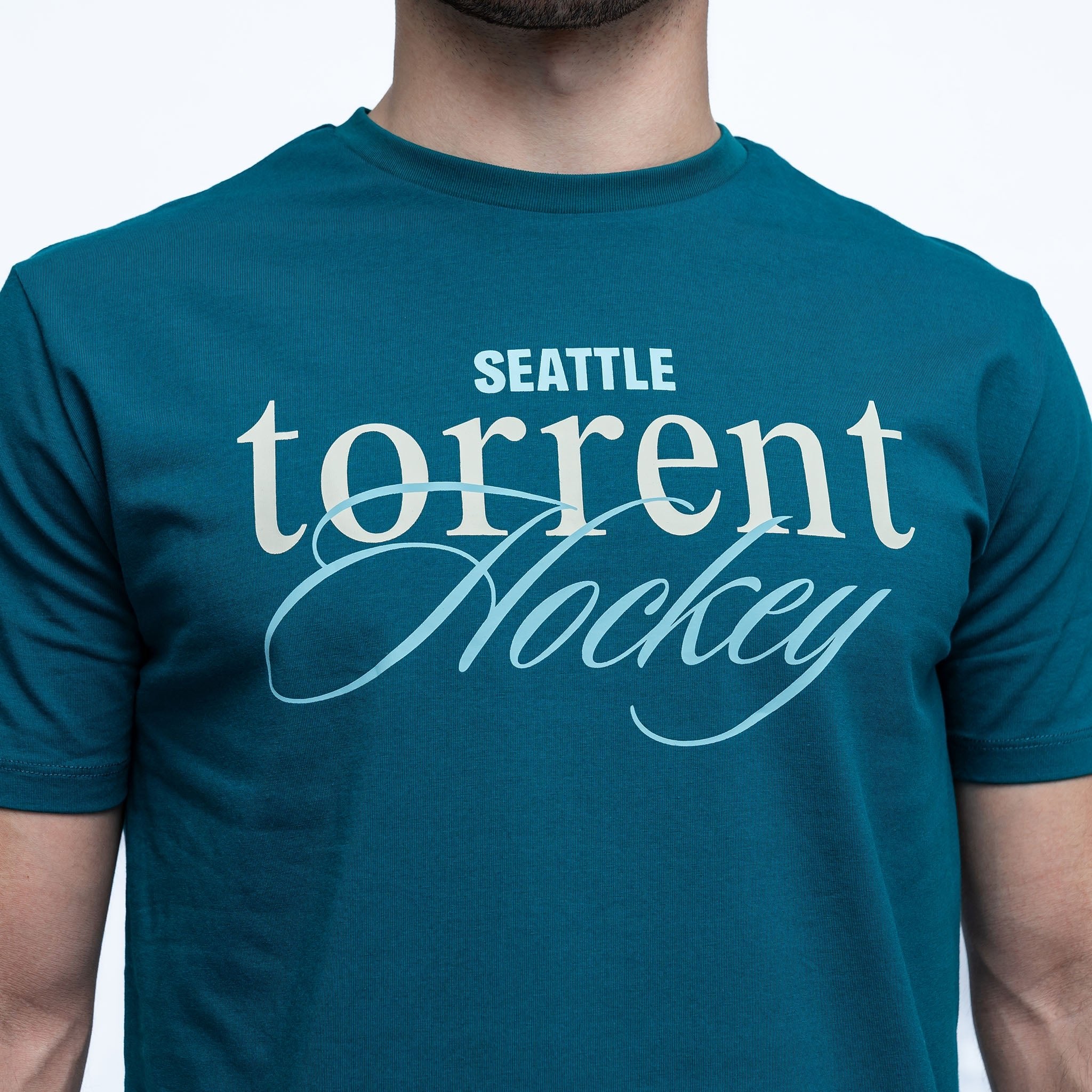 Teal t-shirt with 'Seattle torrent Hockey' text on a white background