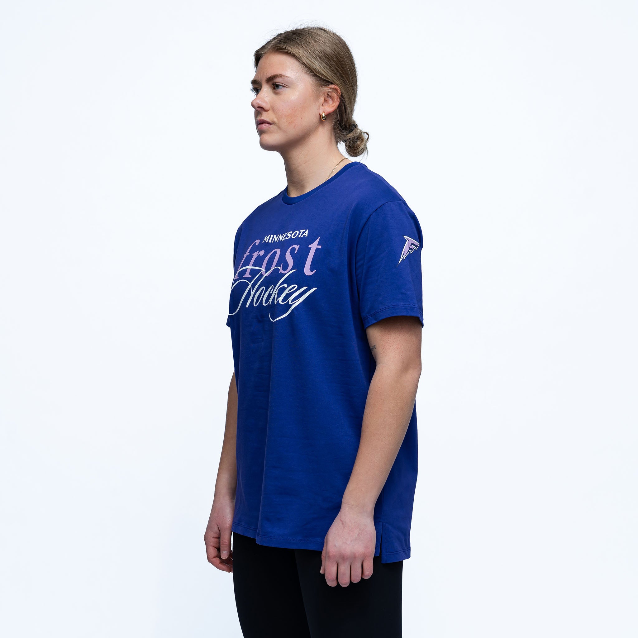 Person wearing a blue 'Hansons Frost Hockey' t-shirt on a white background