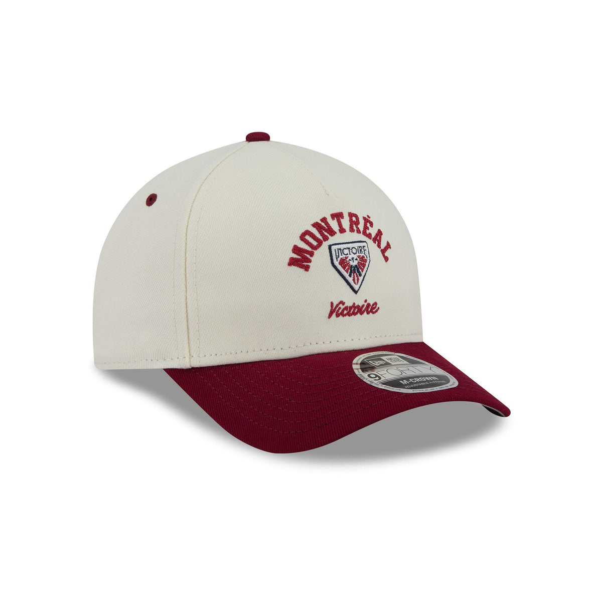 A structured baseball cap featuring an off-white crown with embroidered red and black Montreal Victoire graphics, and a contrasting dark red visor. A silver and black New Era 9FIFTY sticker is visible on the brim.