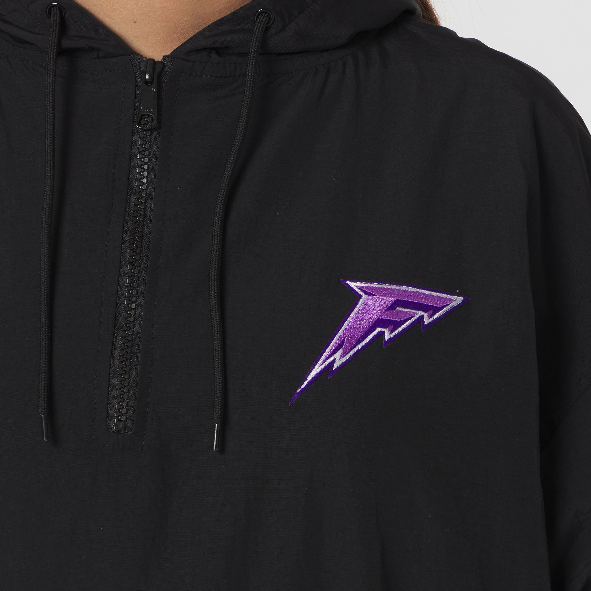 Black hoodie with a purple logo on a gray background