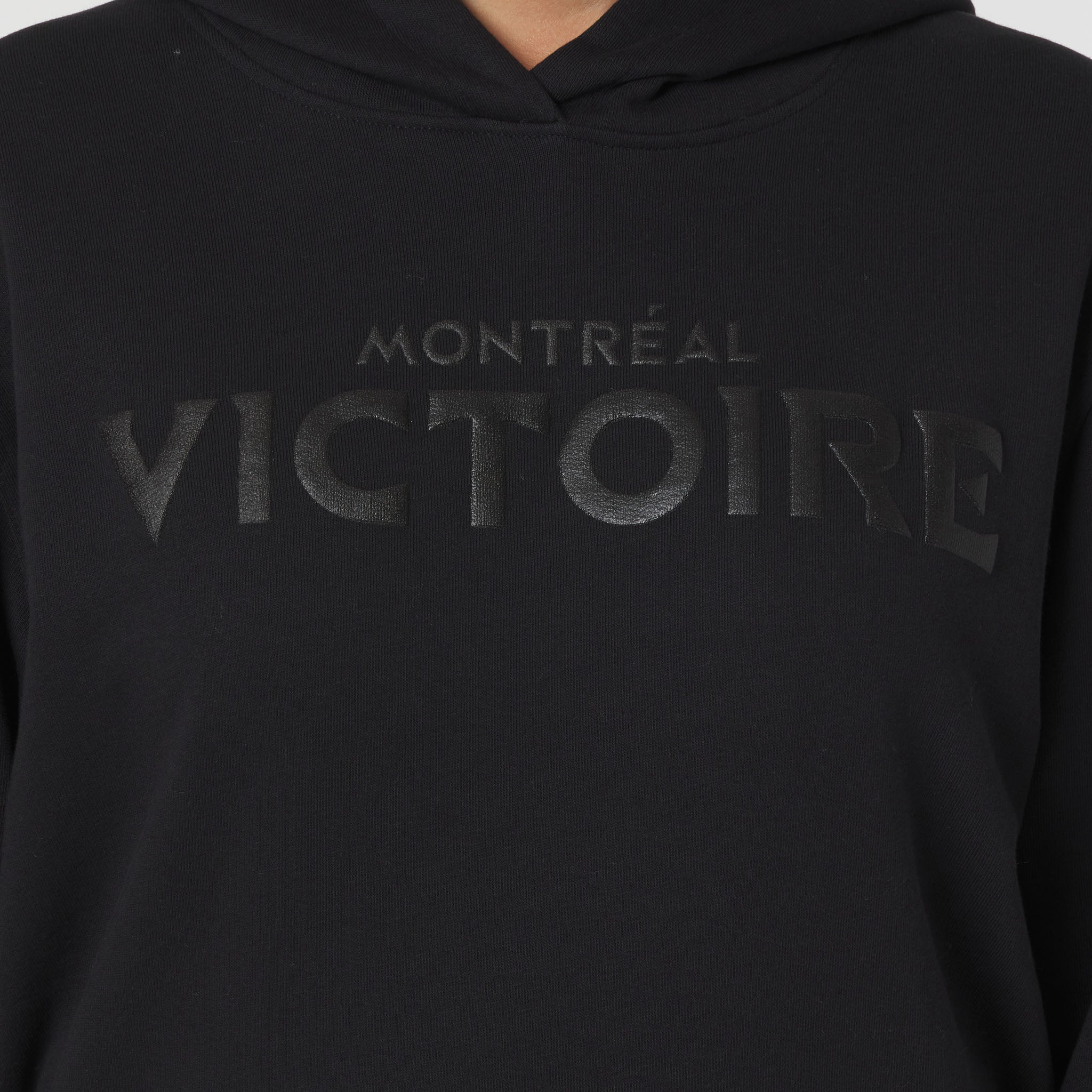 Black hoodie with 'Montreal Victoire' text on a plain background